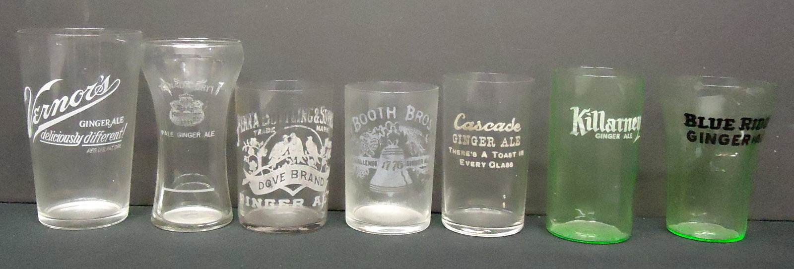 GINGER ALE GLASSES (7): Etched and applied lettering; Vernor's, Blue Ridge (Green), Killarney (Green); Cascade; Dove Brand; Booth Bros; Canada Dry; a few edge flakes, some worn; H-3 1/2"-5"; F-G