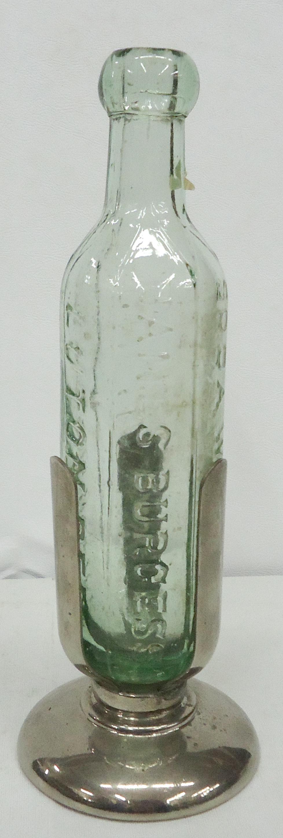 SODA FOUNTAIN BOTTLE & HOLDER: Green embossed rounded bottom bottle; embossed "James Burgess - Champagne Nectar -Ginger Beer - Lemonade - Soda Waters" in metal holder; normal wear; H-11"; G-VG