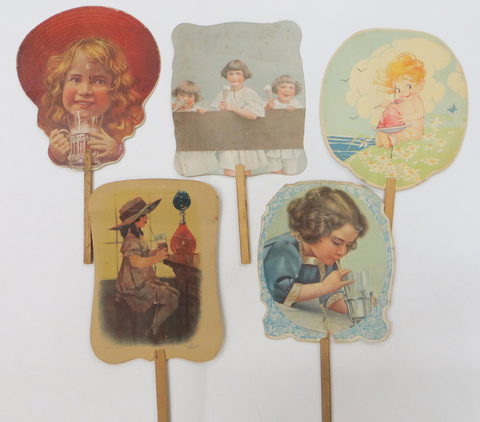 ICE CREAM & SODA ADVERTISING FANS (5): Litho cardboard; (1) Young's Pharmacy; (1) Knudsen Ice Cream, PA; (1) Louis Drug, Michigan; (1) Knauer & Castor, Law, Philadelphia; (1) Wagners Confectionary, Ohio; some with creases and tears; H-13"-