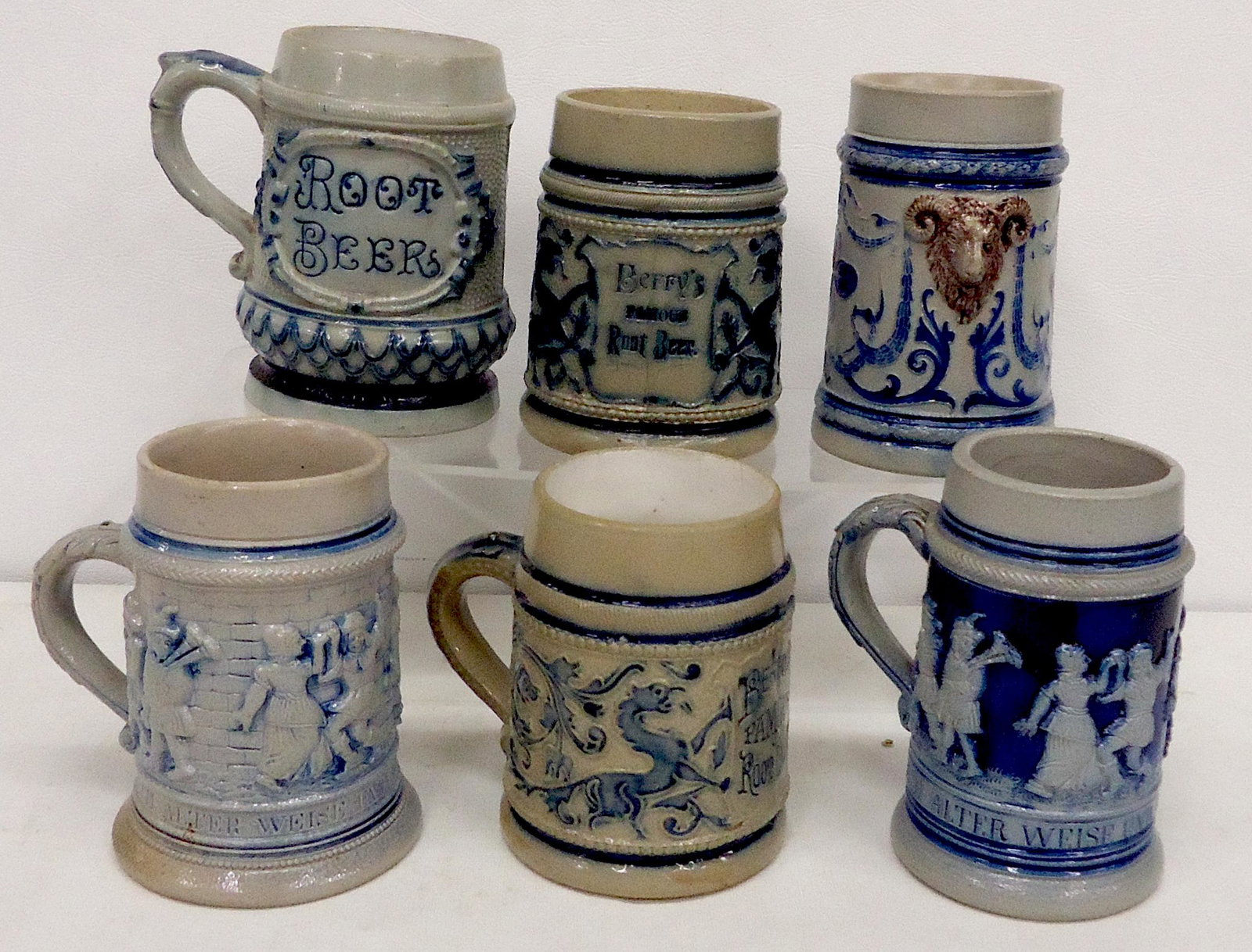 STONEWARE MUGS (6): Blue decoration; (2) Berry's Famous Root Beer, variations; (1) Root Beer; (1) Unmarked; (2) hairline, (1) handle crack; normal wear; H-4 1/2"; G-VG