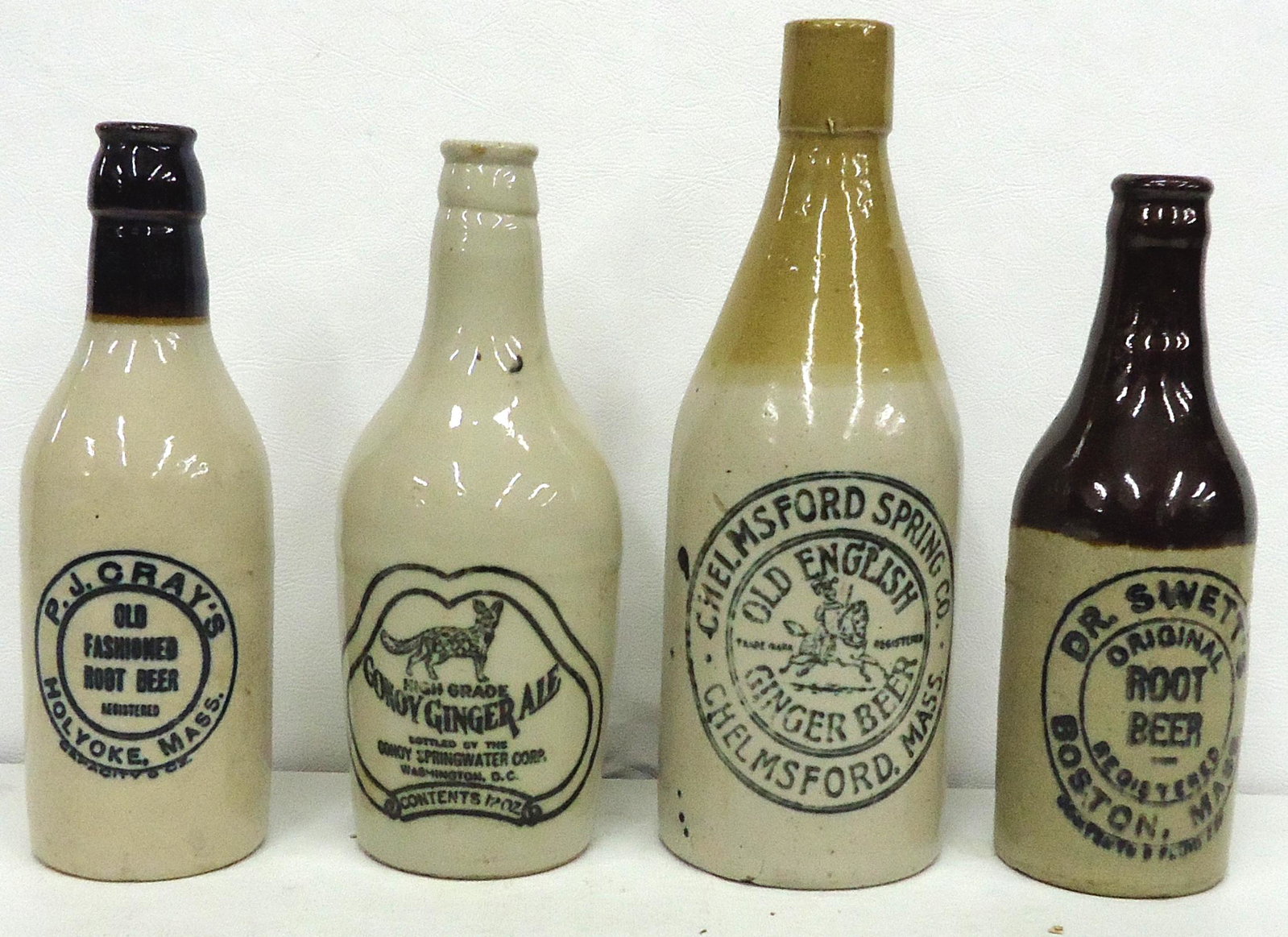 STONEWARE SODA BOTTLES (4): (1) Dr. Swetts Root Beer; (1) P.J. Cray Root Beer; (1) Chelmsford Ginger Beer; (1) Conoy Ginger Ale; normal wear; H-8"-9 1/2"; G-VG