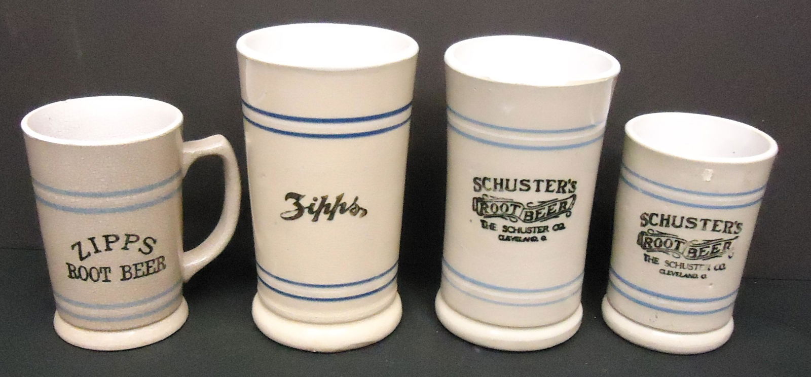 ROOT BEER MUGS (4): Ceramic; (2) Schusters, size variation; (2) Zipps, different, (1) crazed; H-4 1/2"-6 1/2: G-VG