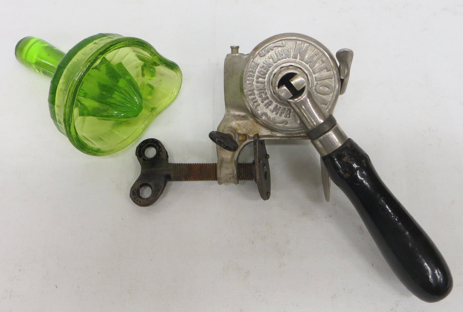 SODA FOUNTAIN JUICERS (2): (1) National counter-mount squeezer - nickel plate with wood handle; (1) green glass hand held juicer; normal wear; H-5"-8", G-VG