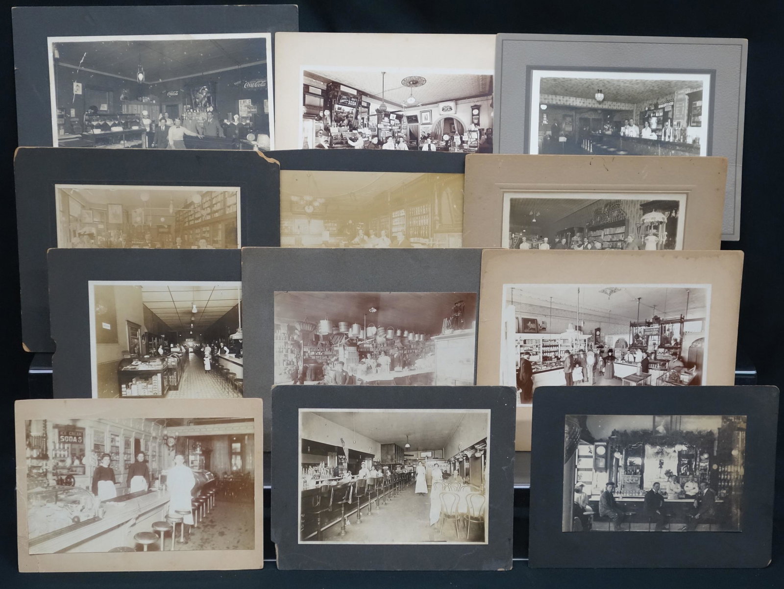 VINTAGE SODA FOUNTAIN / STORE PHOTOS (12): All have fountains and groups of people; normal wear and fading; some boards chipped; 5" x 8", G-VG