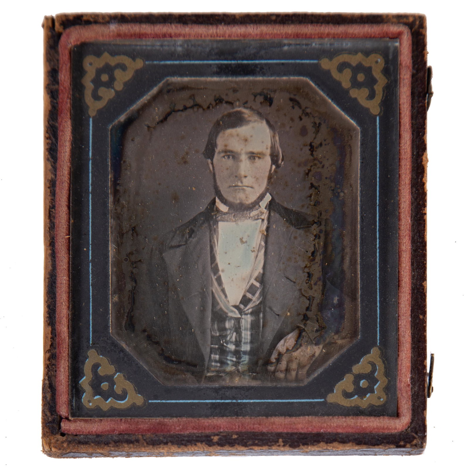 EARLY DAGUERREOTYPE IMAGE OF GENTLEMAN: Ninth plate; image of gentleman with beard and plaid vest; tinted shirt; geometric cardboard mat; pressed leather case with swan; missing half case; case: fair; image: fatigue; F