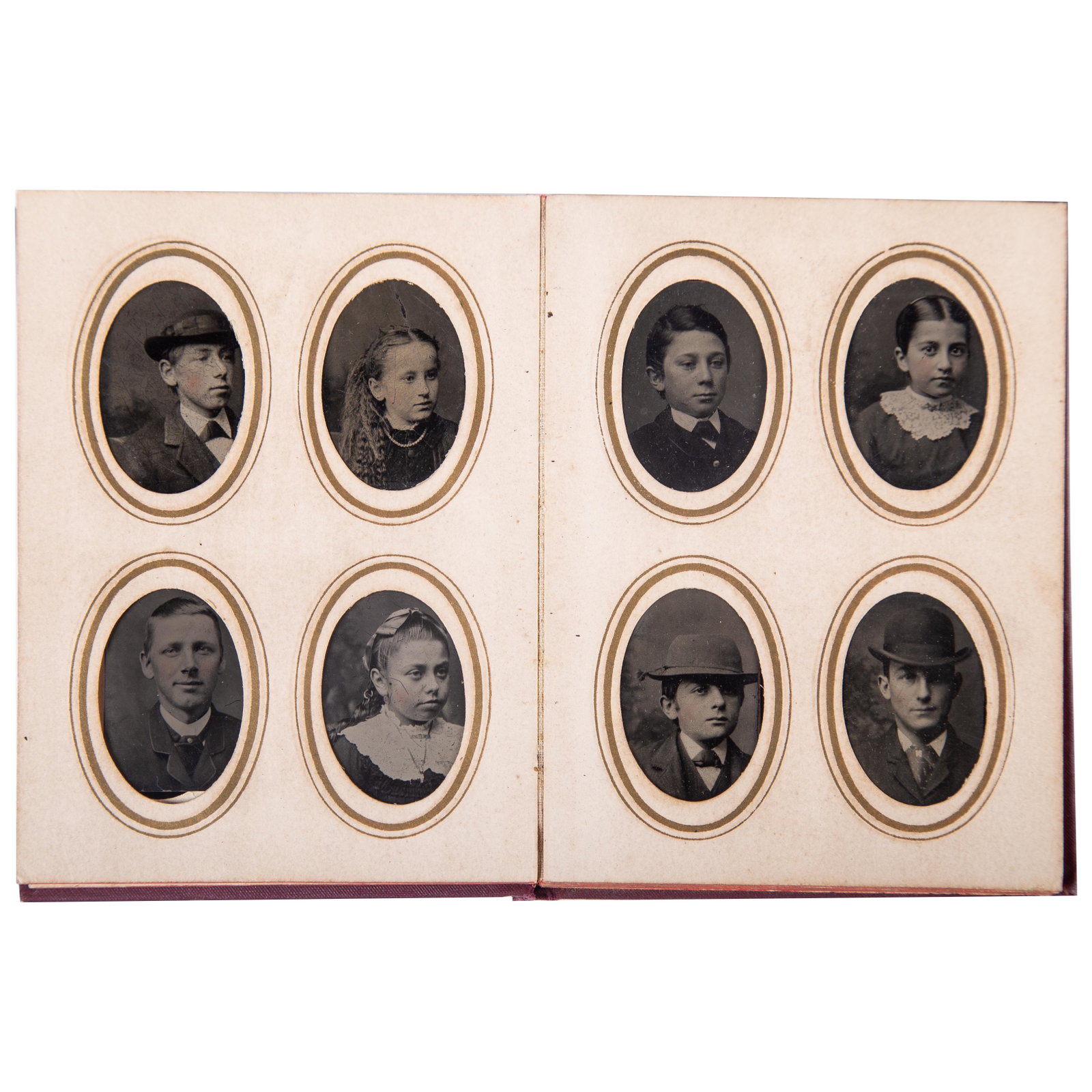 TINTYPE PHOTO ALBUM: Miniature tintypes of mostyl children and young adults (20); two pages empty; cloth cover; image 1 1/2" x 1", G-VG