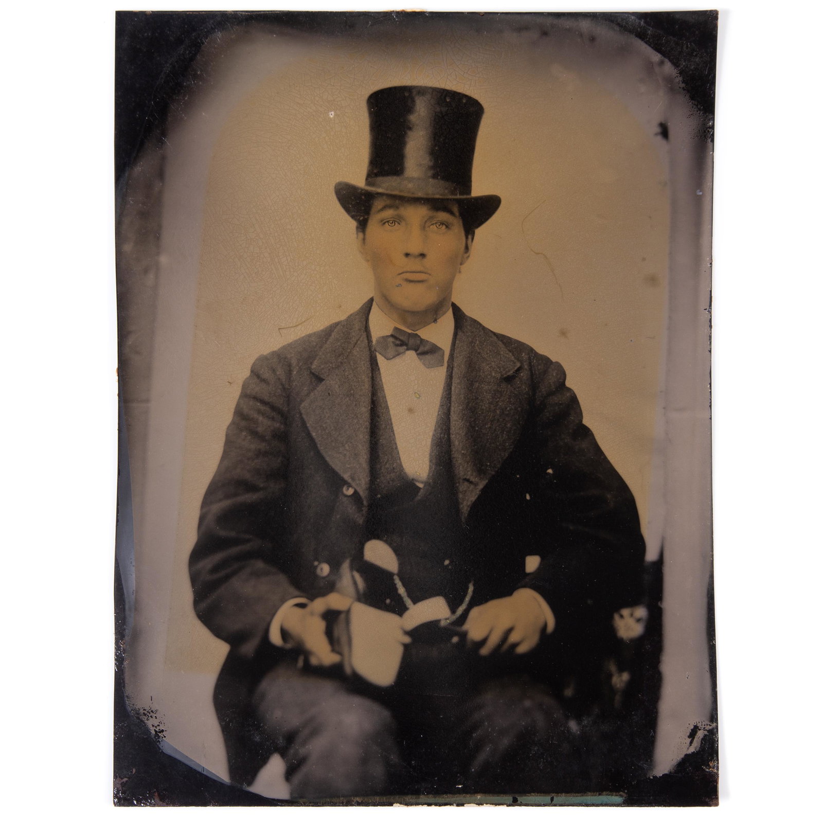 OCCUPATIONAL TINTYPE GENTLEMAN COBBLER: Full plate; image of well-dressed young man in top hat holding a shoe and a hammer; no mat; no case; some yellow shading and crazing; G-VG