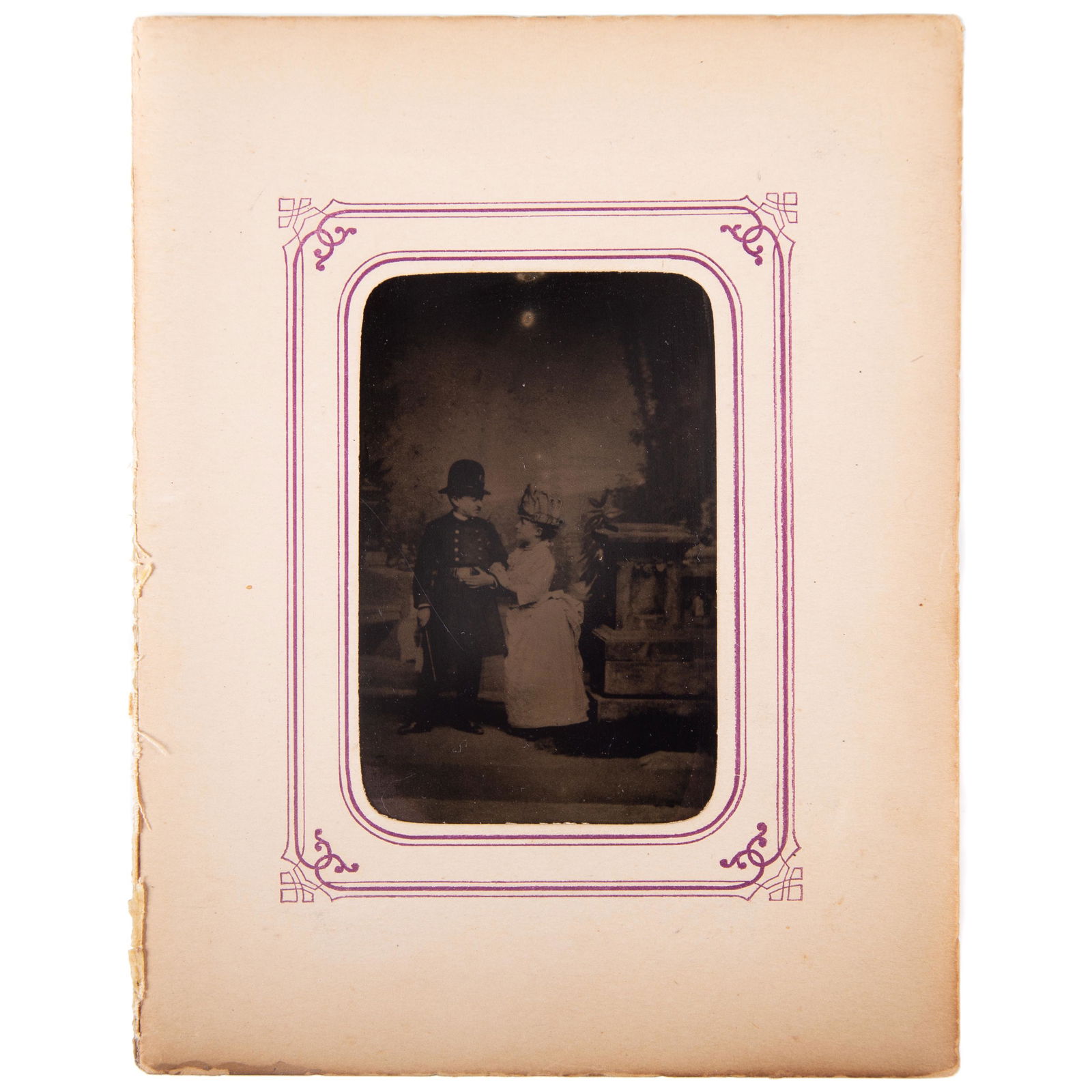 TINTYPE MIDGETS: 6th plate; image of two little people; male dressed as copper, woman with bustle; matted; somewhat dark; G-VG