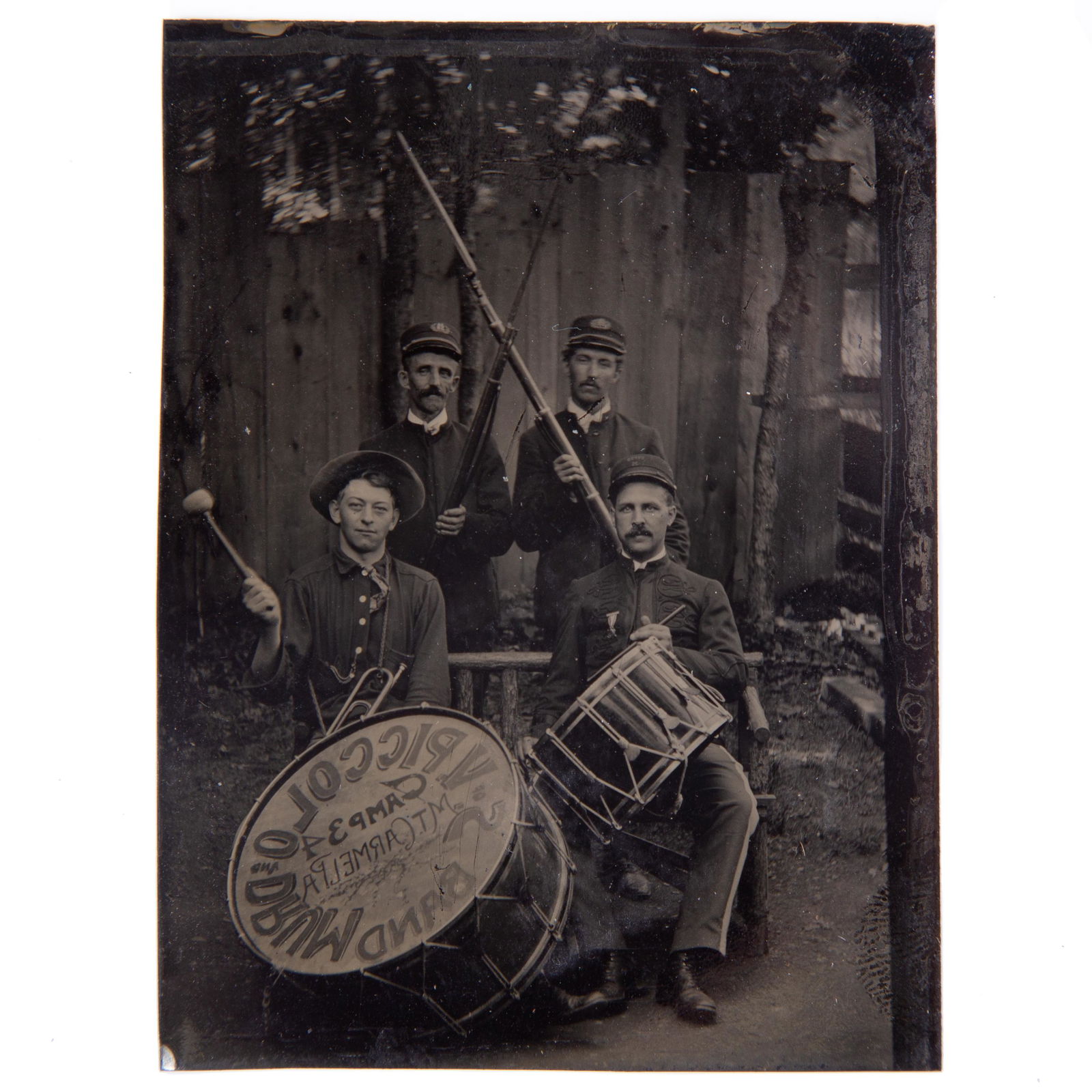 MILITARY BAND TINTYPE: 6th plate; image of military dressed soldiers with guns and drums; large bass drum reads "V. Piccolo Drum Band - Camp 34 Mt. Carmel, PA"; paper mat; light blemishes; VG-VG+