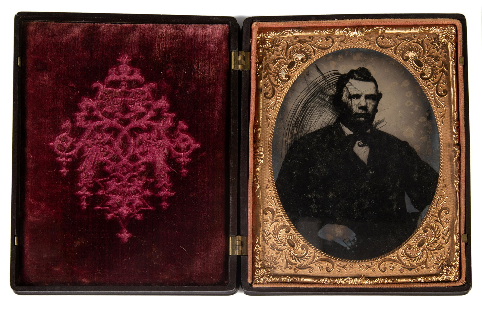 LARGE GUTTA PERCHA CASE WITH TINTYPE: Half plate; image of gentleman , unfortunately rubbed; in Littlefield & Parsons Union urn of fruit double sided case; broadside label under image; (2) small edge cracks and minor edge roughness; 4 1/2