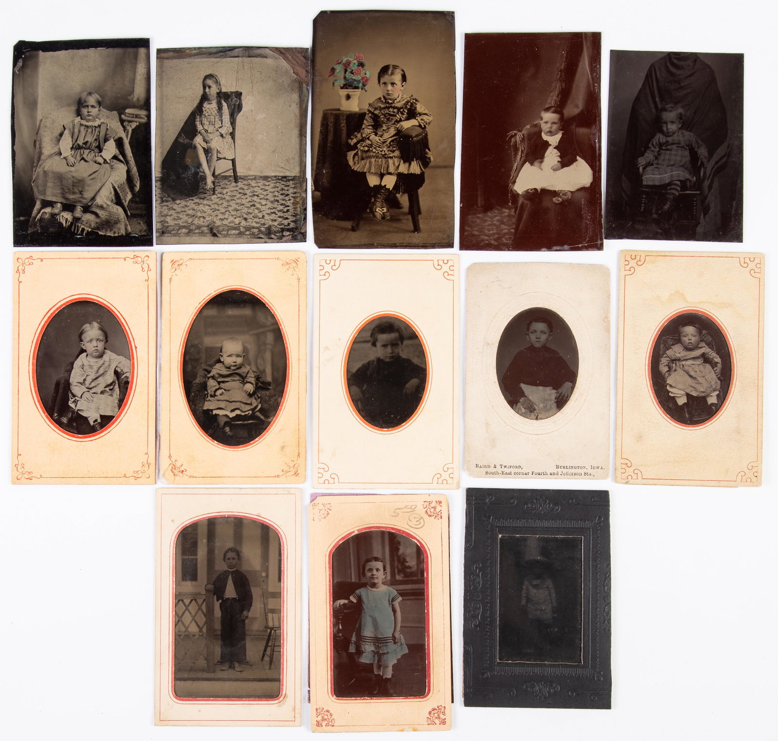 TINTYPES OF YOUNG CHILDREN & INFANTS (13): 6th plate; (2) with color; (1) with highlighted cheeks; (8) with paper mats, 1- of which is "Baird & Twiford, Iowa"; no cases; some darkened; G-VG