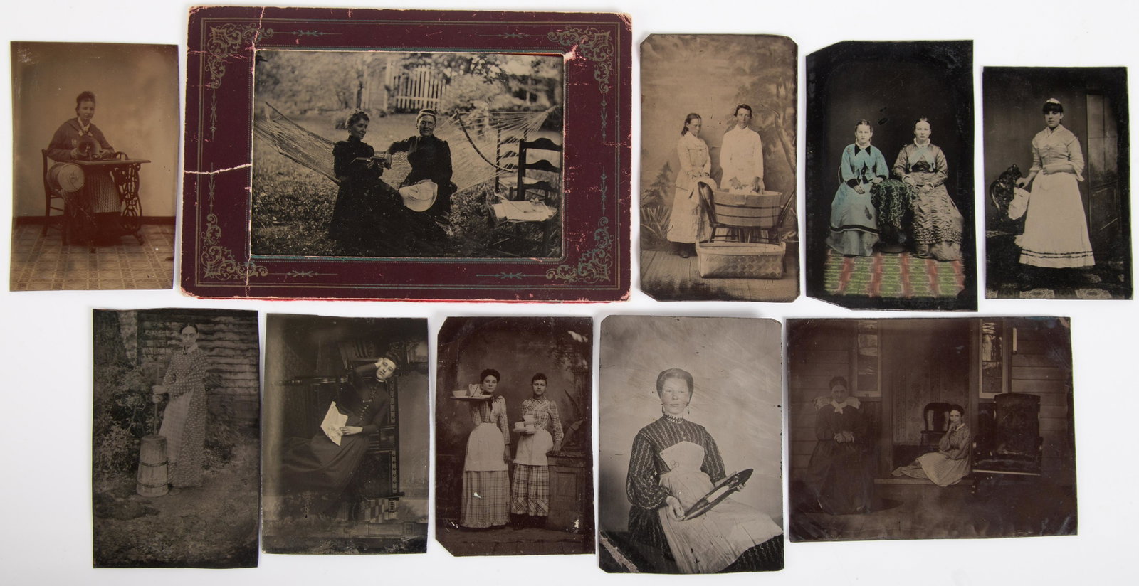 WOMEN AND OCCUPATIONAL TINTYPES (10): 6th plate to large quarter plate; woman butter churn, woman at sewing machine, women servants, women socializing; (1) in paper mat; normal wear; some dark; G-VG