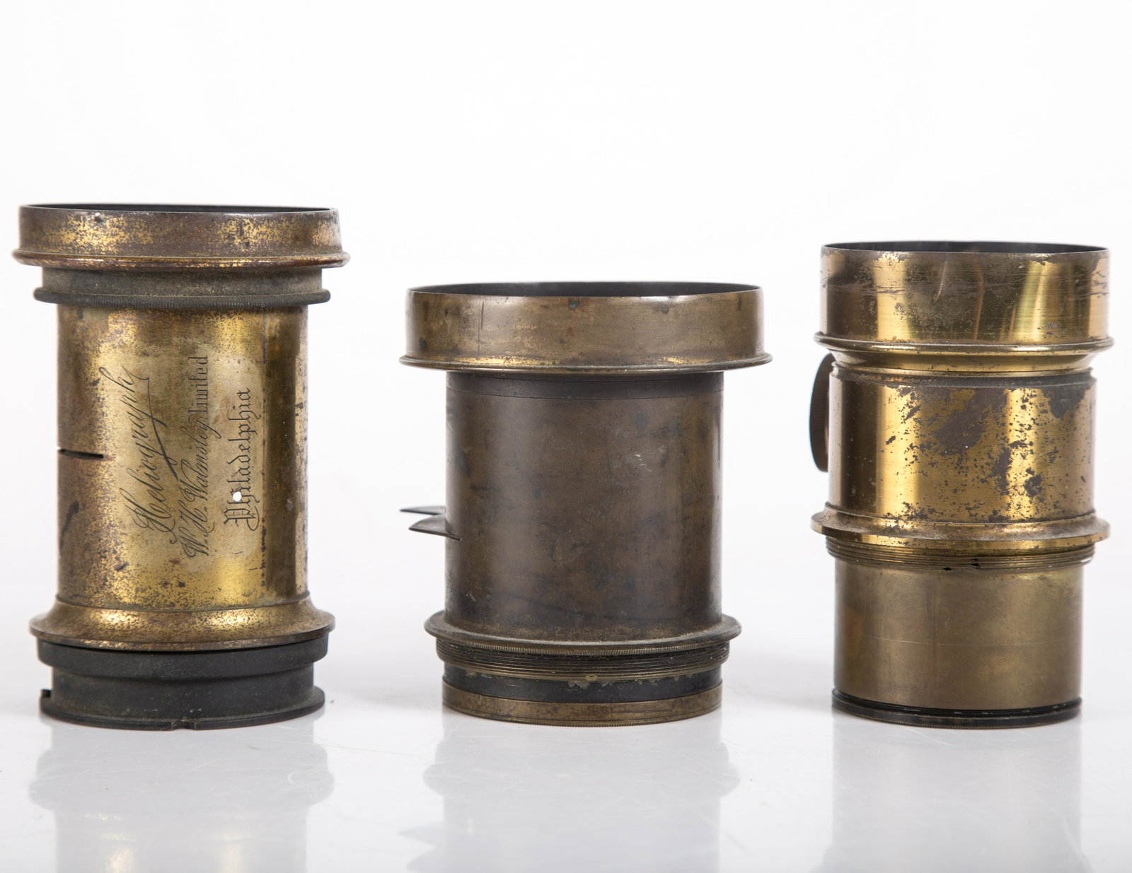 PHOTOGRAPHIC LENS (3): (1) Acme brass lens with Water House stop; (1) Heliography brass lens Walmsley Phila.; (1) brass lens; normal wear; L-4"-4 1/4", G-VG