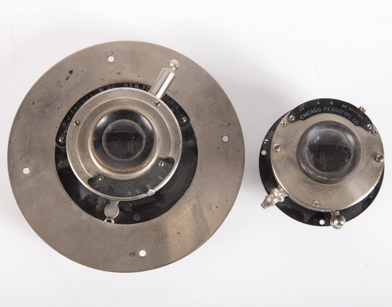 PHOTOGRAPHIC LENS (2): (1) Chicago Ferrotype; (1) W. J. Thompson Co., N.Y.; wear; G-G+