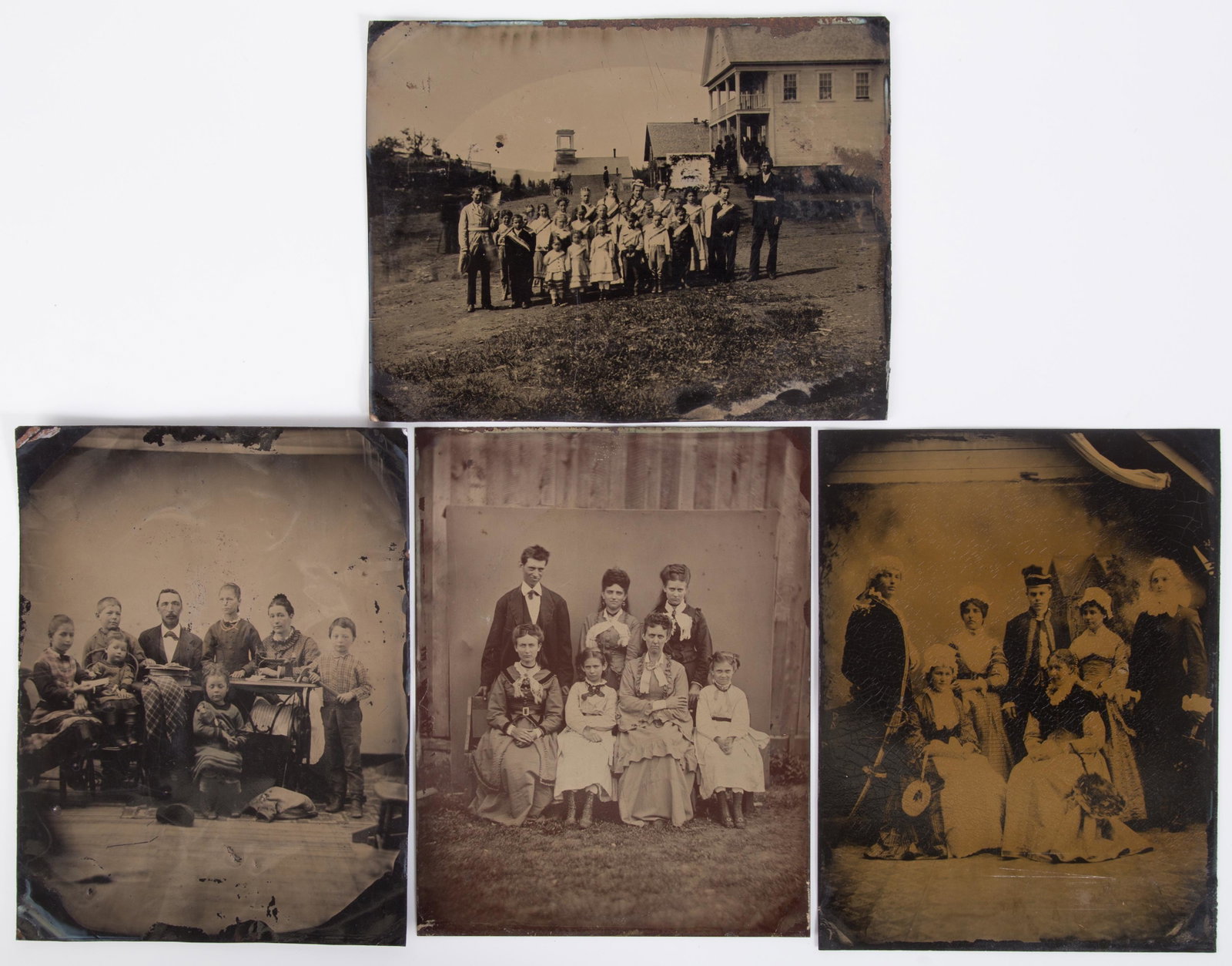 GROUP PORTRAIT TINTYPES (4): Full plate; families, school or church group, actors in a theatre group; woman with sewing machine with family; minor blemishes; G-VG