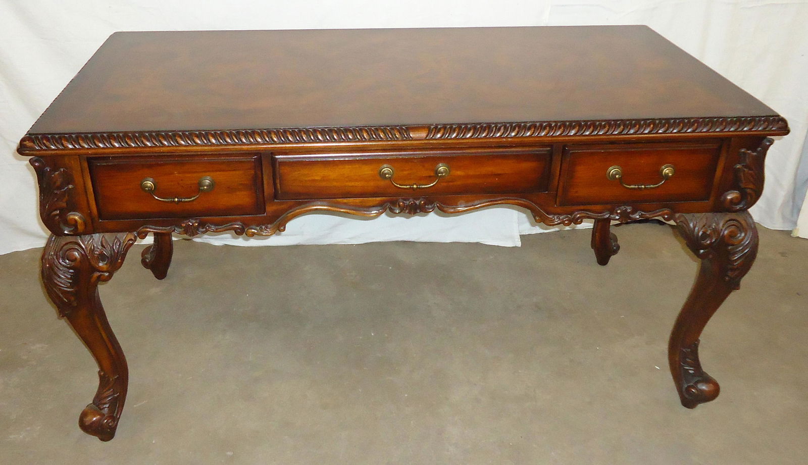 HOOKER EXECUTIVE DESK: "Seven Seas"; mahogany and burl mahogany; foliate carved; three drawers; normal wear; H-31", L-60", Depth-30", VG-EX