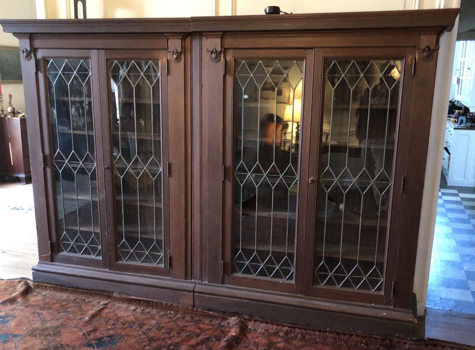 VICTORIAN BOOKCASE: Gothic style; two section with four leaded glass doors; mixed woods; some broken glass; wear; H-76", L-112", F-G