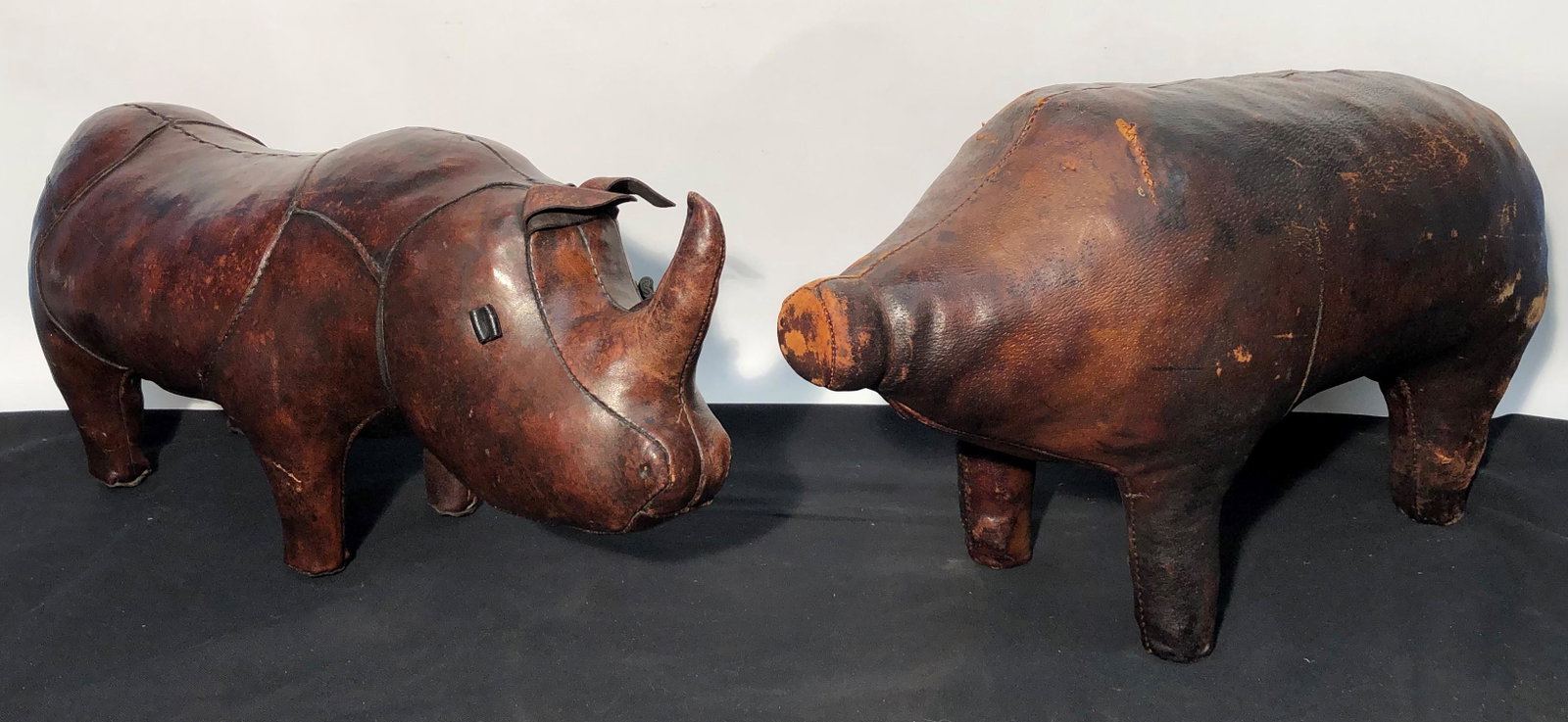 PIG AND RHINO FOOTSTOOL: Leather; pig worn and missing ears; L-25", F-G