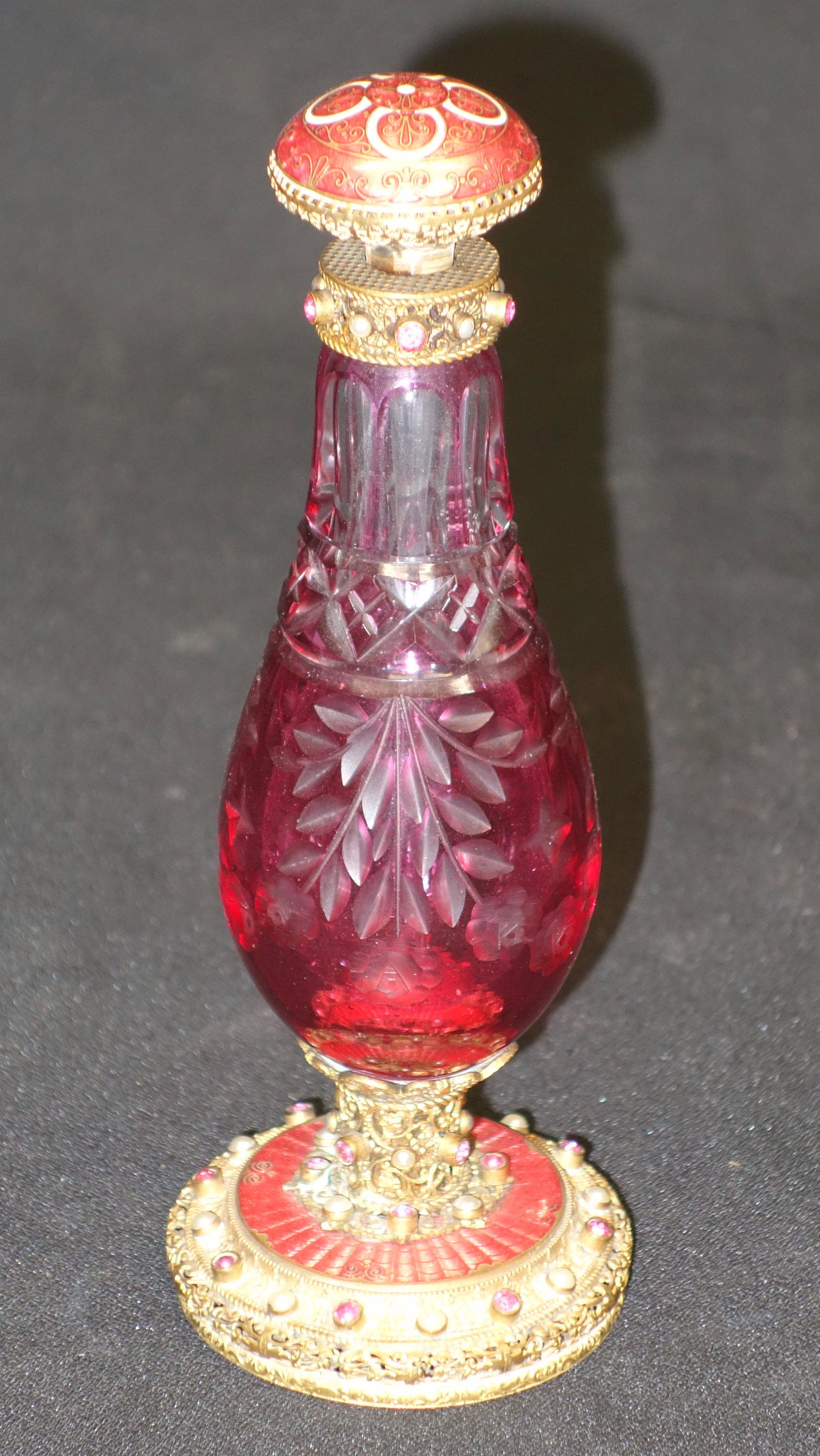 ENAMELED BRONZE PERFUME: Cut cranberry to clear bottle with enameled bronze cap and base; jewel and pearl encrusted with decorative cloisonne in enameling; pontil intact; normal wear; H-7 1/2", VG-EX