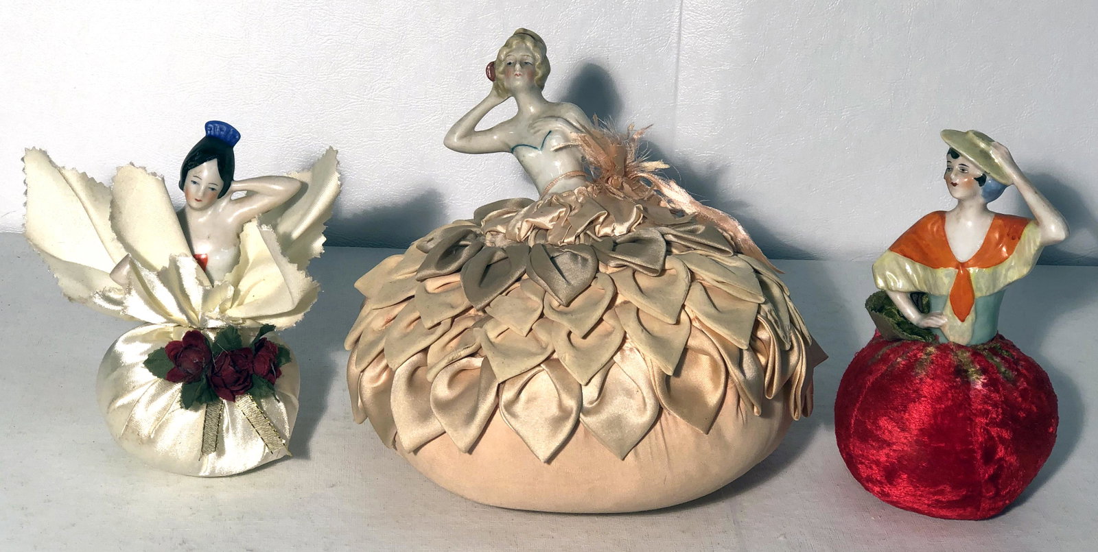 PIN CUSHION DOLLS (3): China and cloth; largest repaired; H-6"-8", P-G