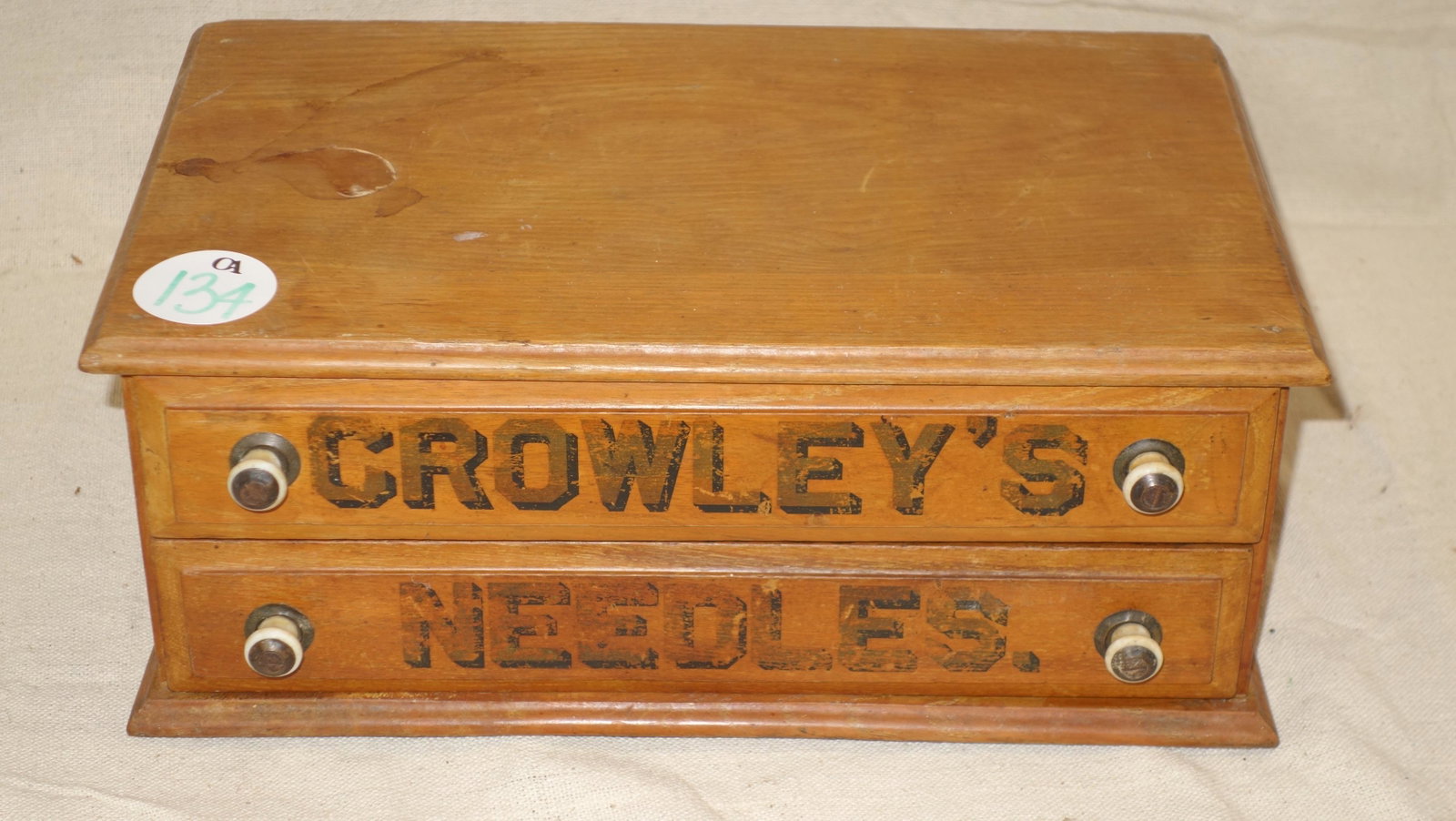 CROWLEY'S NEEDLES AD CABINET: (2) drawer cabinet; stain on top; bottom has split; letters show wear; L-13"; G-VG