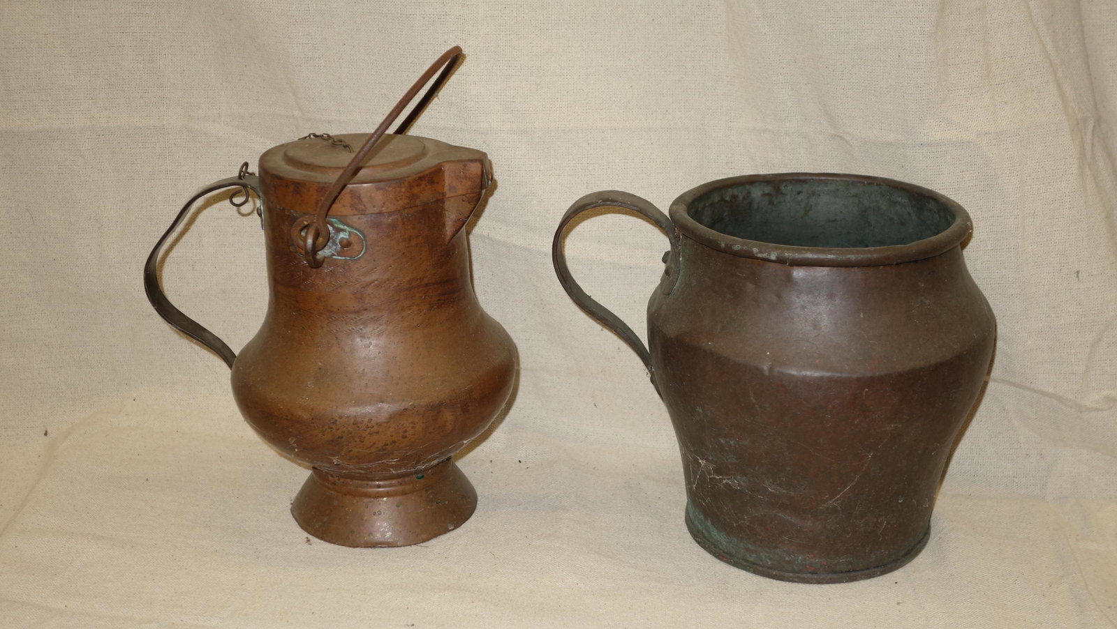 (2) PIECES COPPERWARE: (1) jug with handle; (1) pitcher with chained lid; body has dent; tallest H-10", G-VG