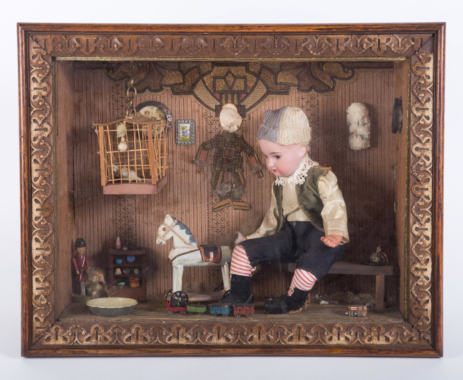 BISQUE HEAD BOY DOLL SHADOWBOX: Hands appear to be plastic; fixed eyes; open mouth; "Wizard's Workbench" stamped on bottom; head has fallen off wall puppet; white fuzzy item on wall (right side) is deteriorating; 15" x 19", G-VG