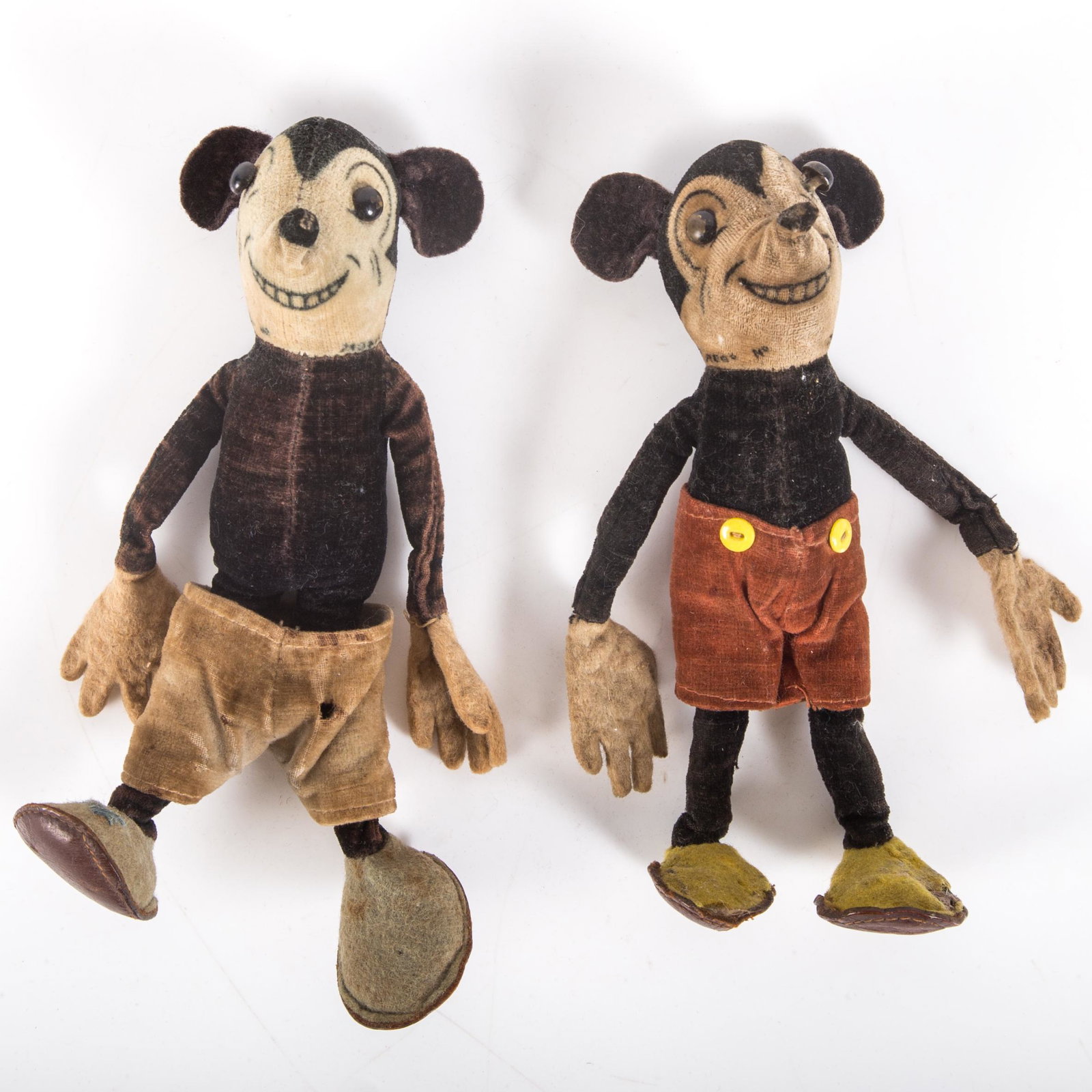 DEAN'S MICKEY DOLLS (2): Velvet and felt with button eyes; no tails; discoloration due to age; fabric weakening in areas; Mickey with red shorts: missing (1) back button, eye paint loss; Mickey with tan shorts: small hole in 