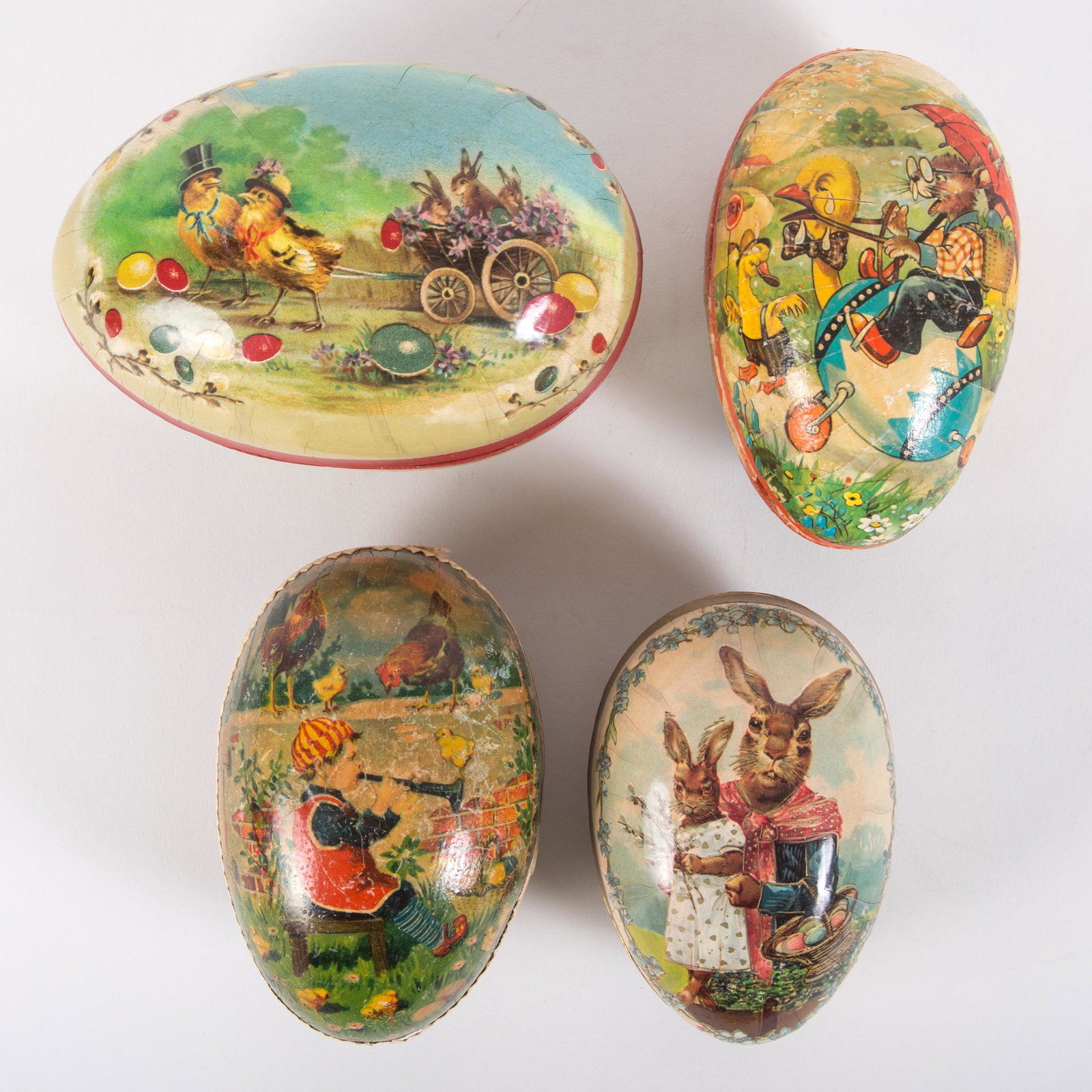EASTER EGG CANDY CONTAINERS (4): Paper litho; (2) marked Germany; (2) are vintage; (1) is hard to close, has some internal tears and misshapen; (1) has some decorative edging loss; normal wear with minor tears; L-5"-6", G-VG