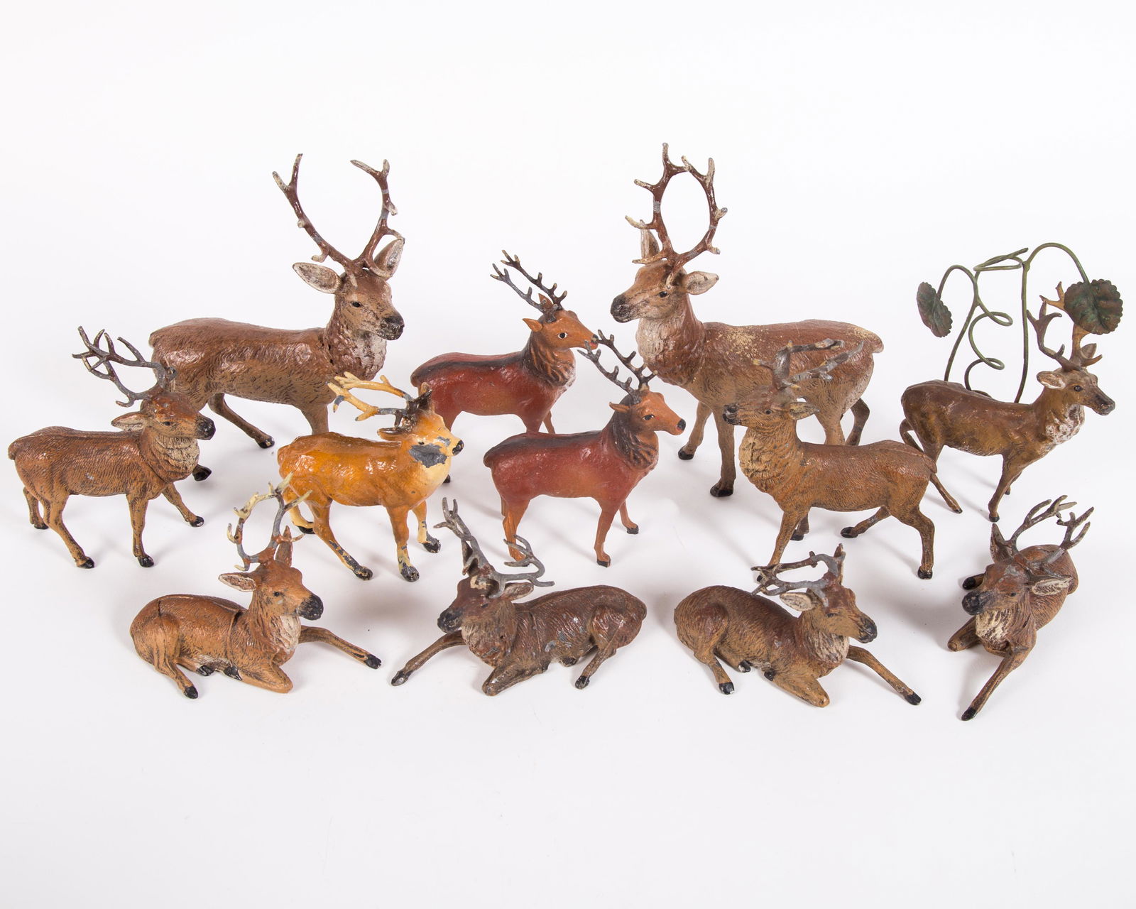 VINTAGE DEER FIGURES (12): (2) are Painted metal and composition with wood legs; (2) are composition; (3) metal are marked Germany; some paint loss, mainly on antlers; some antlers are bent; tallest H-6 1/2", G-VG