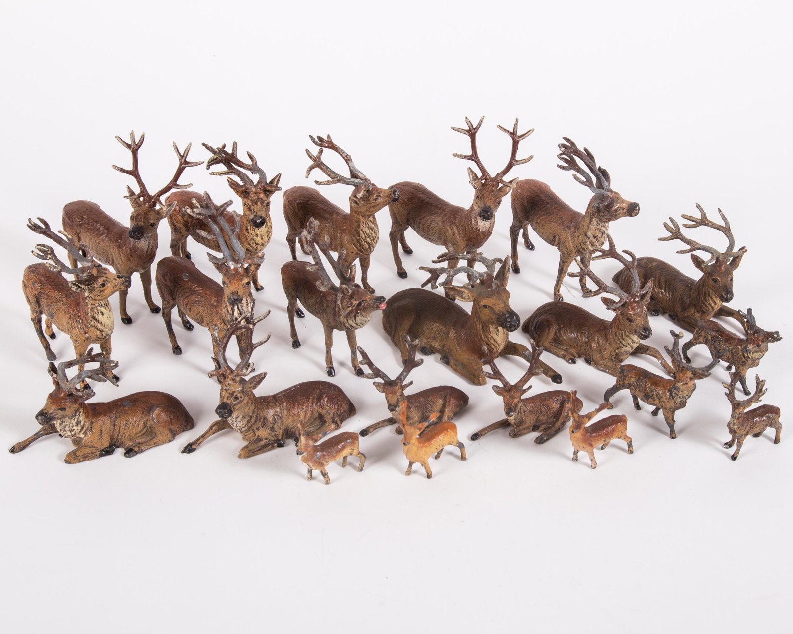 VINTAGE METAL DEER FIGURES (21): Painted metal; some marked "Germany"; some paint loss mainly on antlers; a few antlers have breakage but mainly just bent; L-1 1/2" - 3 1/2"; G-VG
