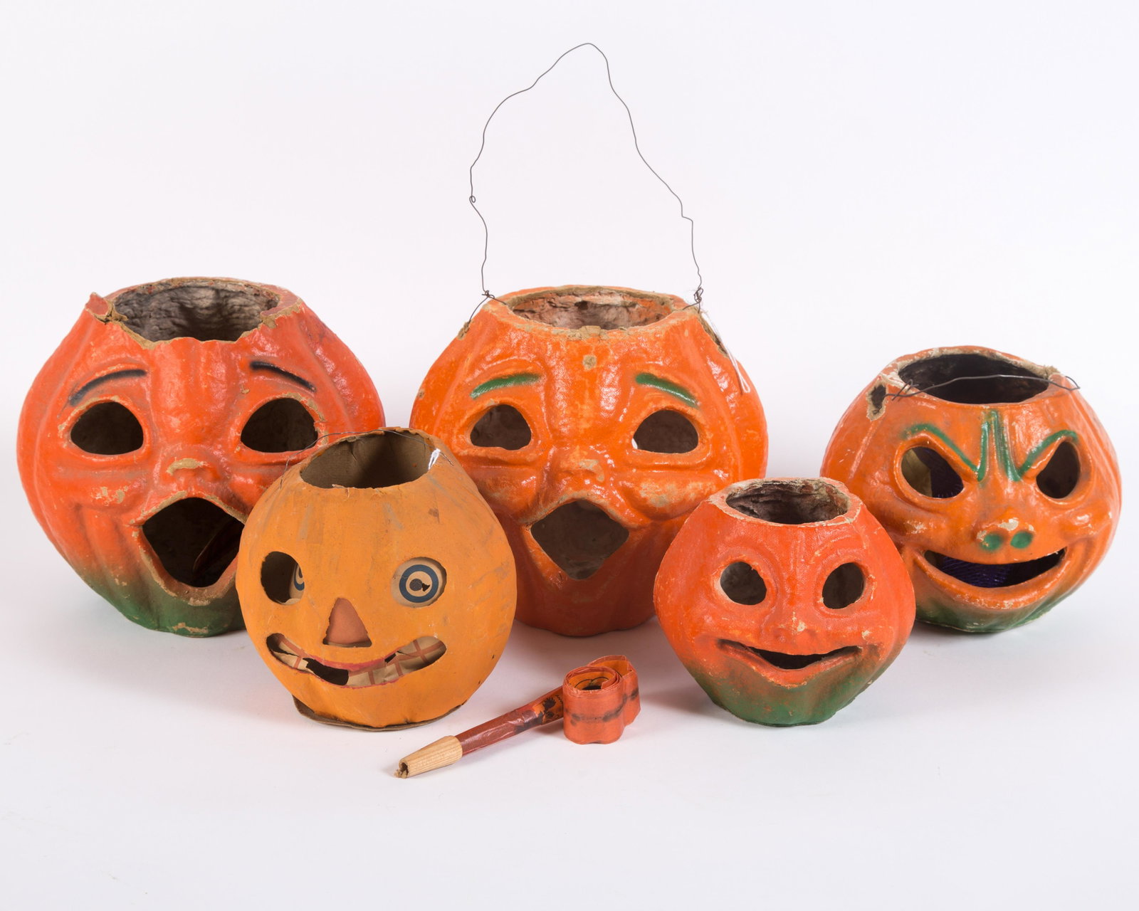 VINTAGE PAPIER MACHE JACK O'LANTERNS (5): (1) Painted molded cardboard with paper insert; (4) painted egg carton; (3) retain wire handle; (1) double-sided; overall paint loss on edges and high spots, around wire holes; minor tearing; tallest 