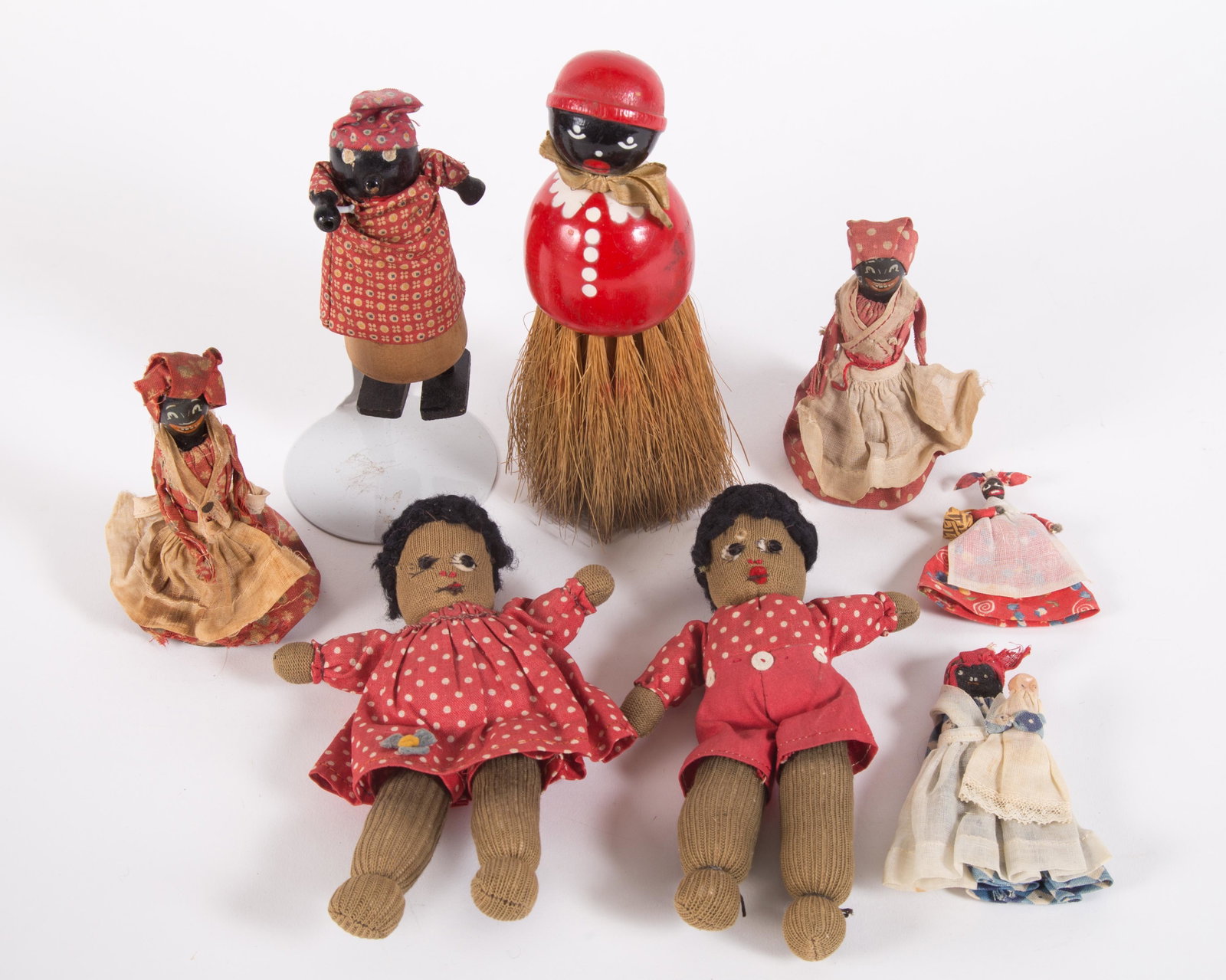 VINTAGE BLACK AMERICANA DOLLS, ETC. (8): Painted wood, cloth and metal; (1) walker, (2) Mammy dressed bells, (1) brush, (4) cloth dolls; some fabric discoloration and small holes; minor paint loss and scuffs on wood; tallest H-7", F-G