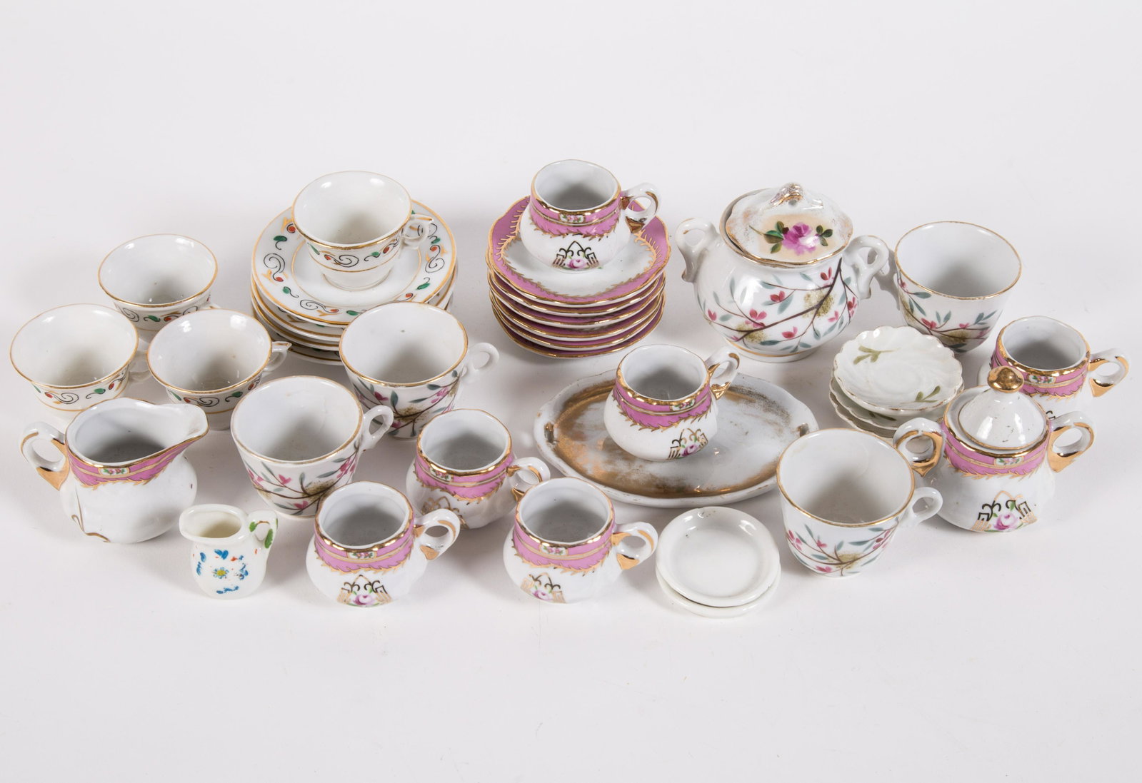 PORCELAIN DOLL DINNERWARE (30+/-) PCS.: (3) different patterns and miscellaneous pieces; normal wear; gilt loss on single plaltter; longest L-4", G-VG