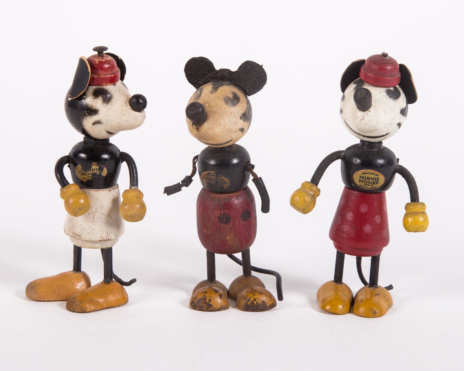 VINTAGE MICKEY AND MINNIE DOLLS (3): Painted wood; (1) Mickey with red hat: retains chest decal; (1) Mickey with no hat: has partial decal, arm breakage, no hands, paint is faded on half of his face; (1) Minnie, retains chest decal; mark