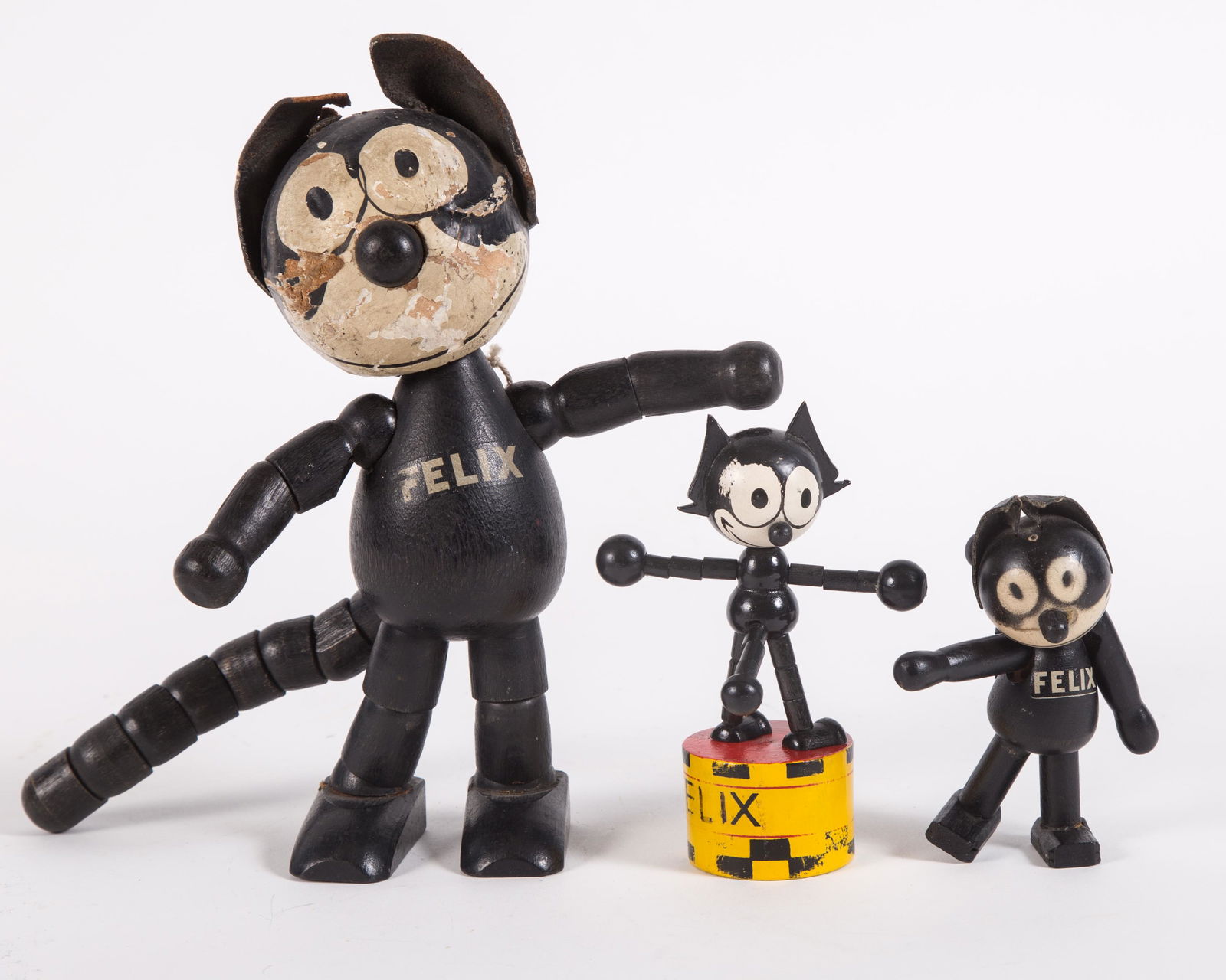 VINTAGE FELIX CAT TOYS (3): Painted wood; (1) push puppet and (2) jointed cats, marked "Sullivan" o n bottom of right foot; push puppet has some paint loss on yellow platform; large jointed Felix - ears brittle and tearing; pain