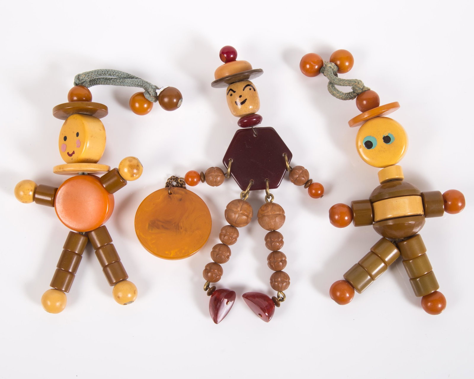 BAKELITE STRNG FIGURES (3): (1) pin, (2) string toys; H-4 1/2", G-VG