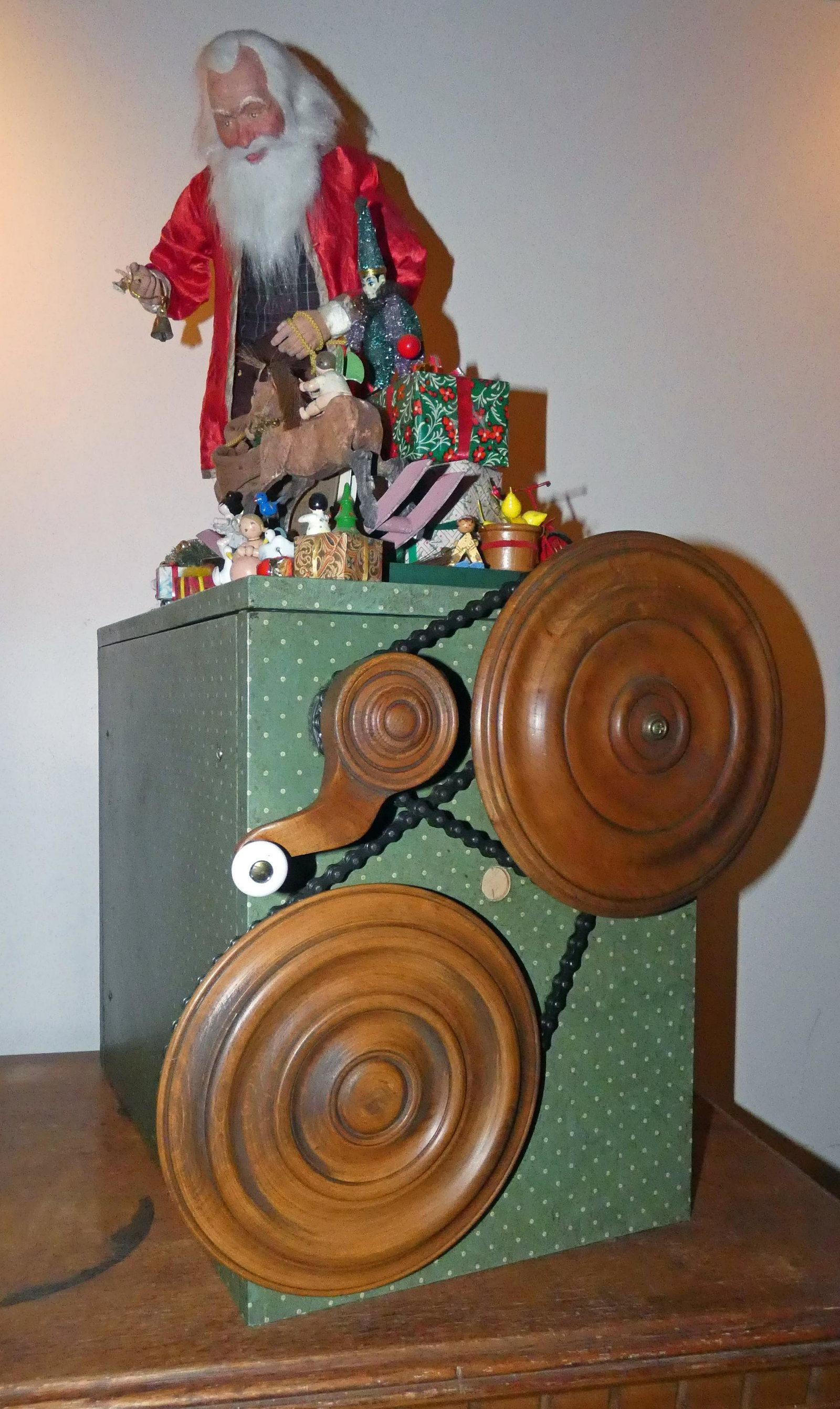 ST. NICHOLAS AUTOMATON: Contemporary; Lawrence Dreschler, maker; crank mechanism animates head, hands and some toys; composition, cloth, assorted toys on covered wood base; together with newspaper article; H-33", VG-EX