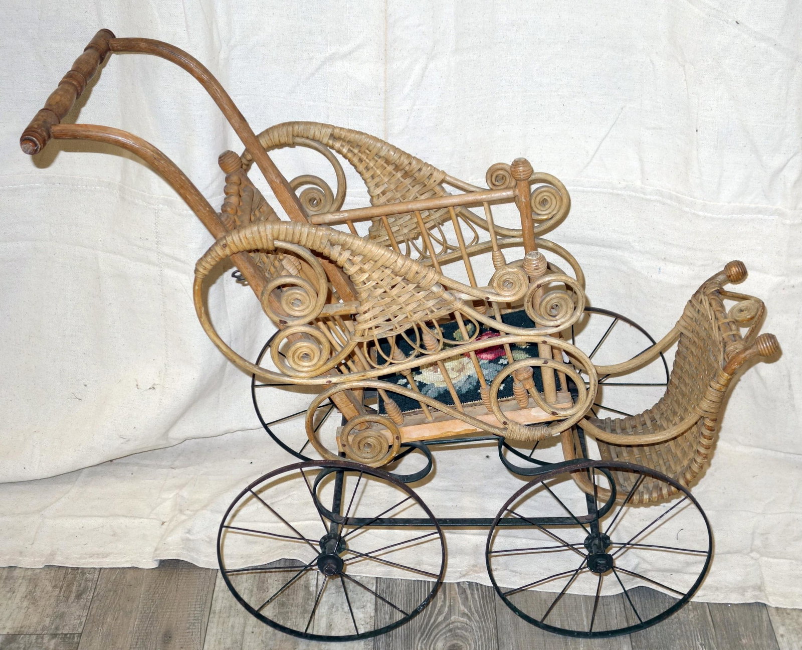 VICTORIAN CHILD SIZE WICKER STROLLER: Needlepoint seat cover; no parisol; normal wear; L-32", G-VG