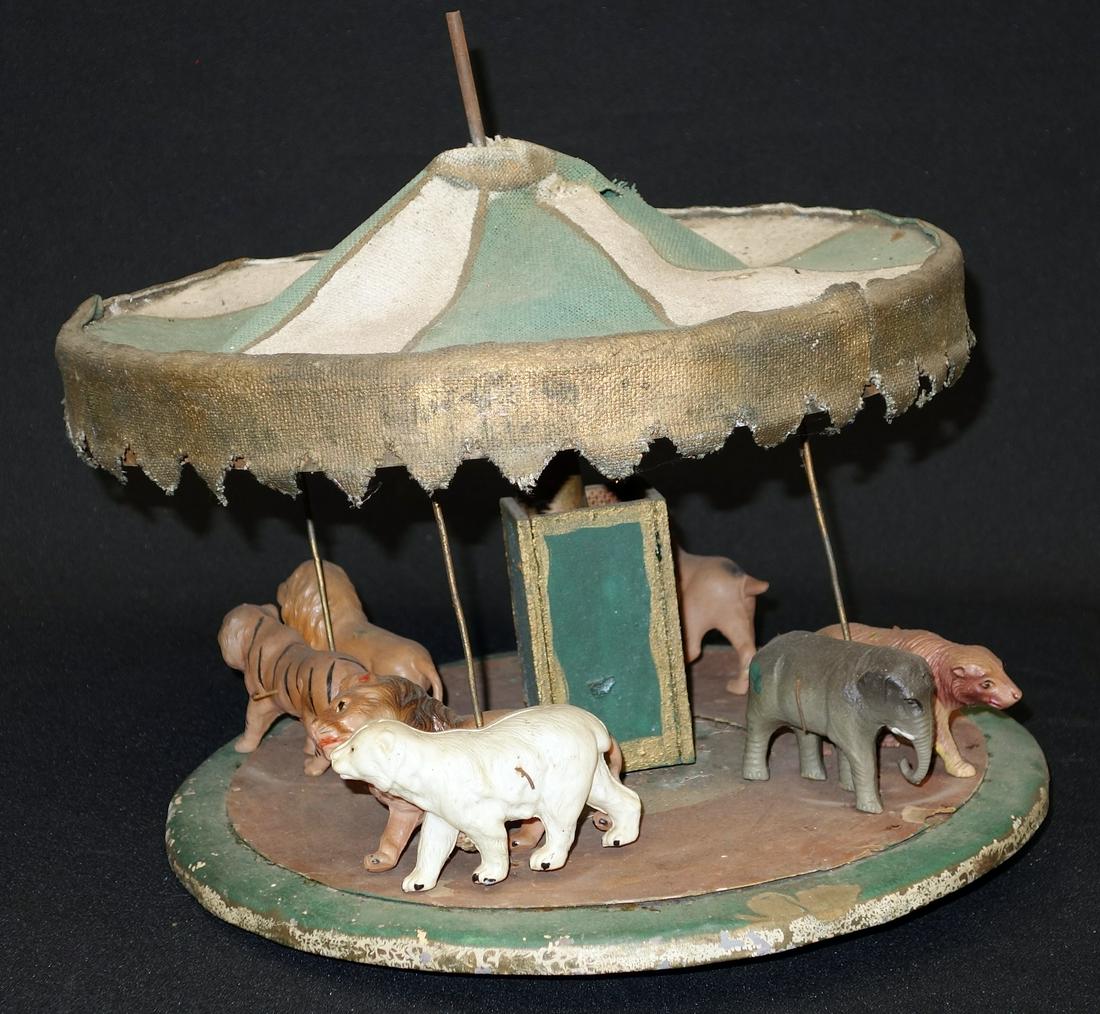 MERRY-GO-ROUND TOY: Cloth, metal and plastic; missing parts; canopy damaged; H-11", P-F