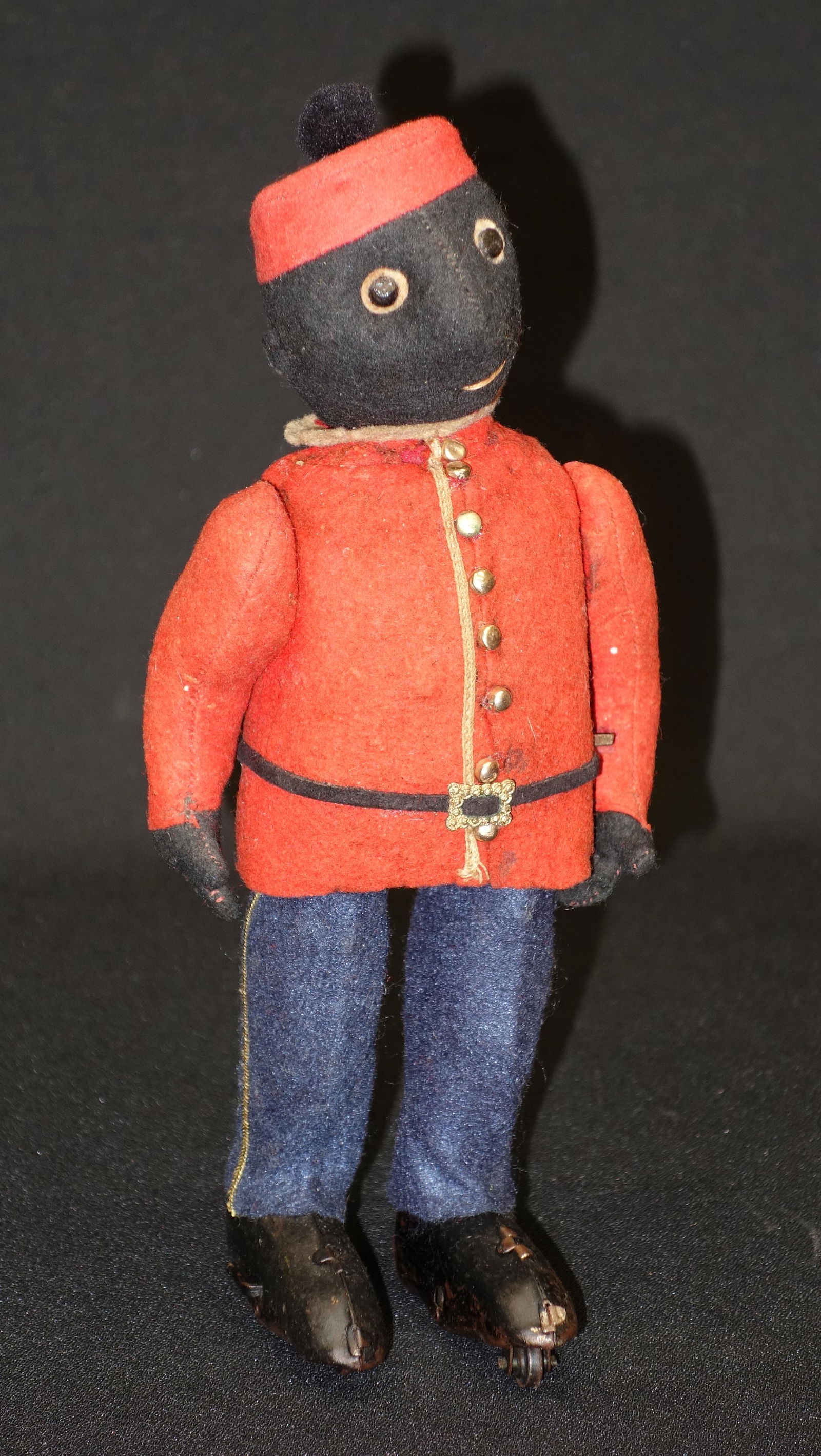 WIND-UP ROLLER SKATING BELLHOP: Possibly Schuco; working with key; wear and holes to uniform; paint loss and wear to skates; H-9 1/2", F-G