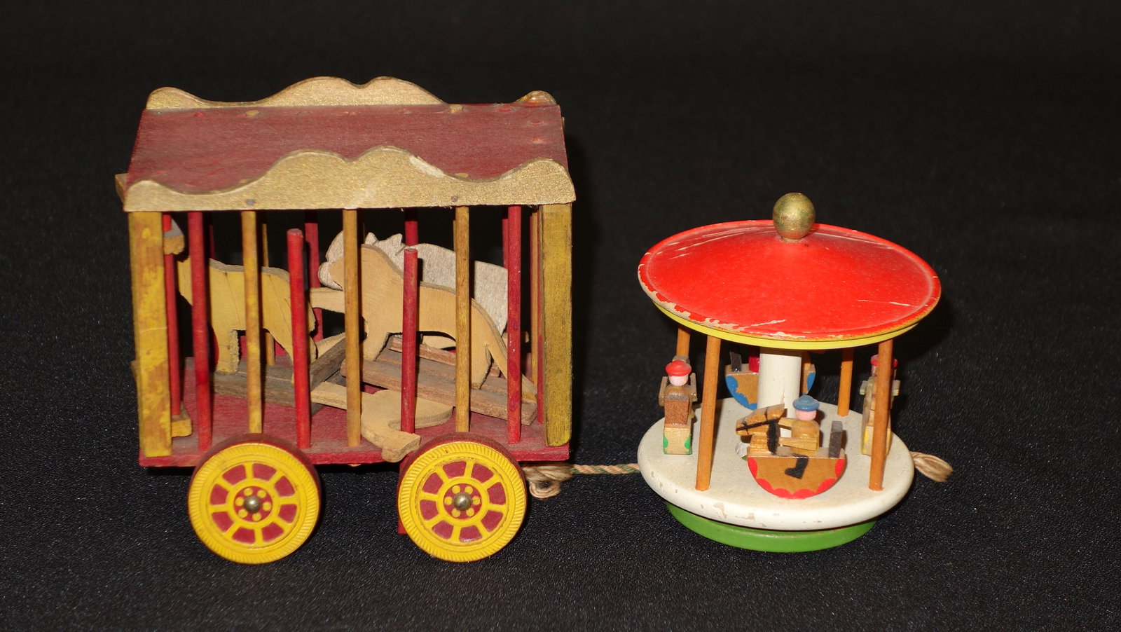 CARVED WOODEN TOYS (2): Circus car and Merry Go Round; paint wear, loss and chips; H-4", F-G
