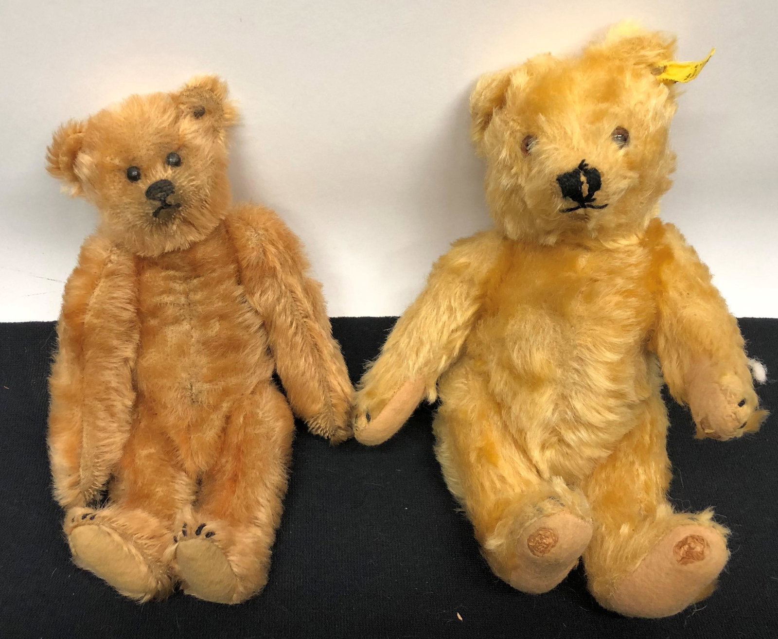 OLDER STEIFF BEARS (2): (1) Ear button and tag; (1) ear button only; (1) has heavy wear to paws; H-9"; (1) normal wear; G-VG