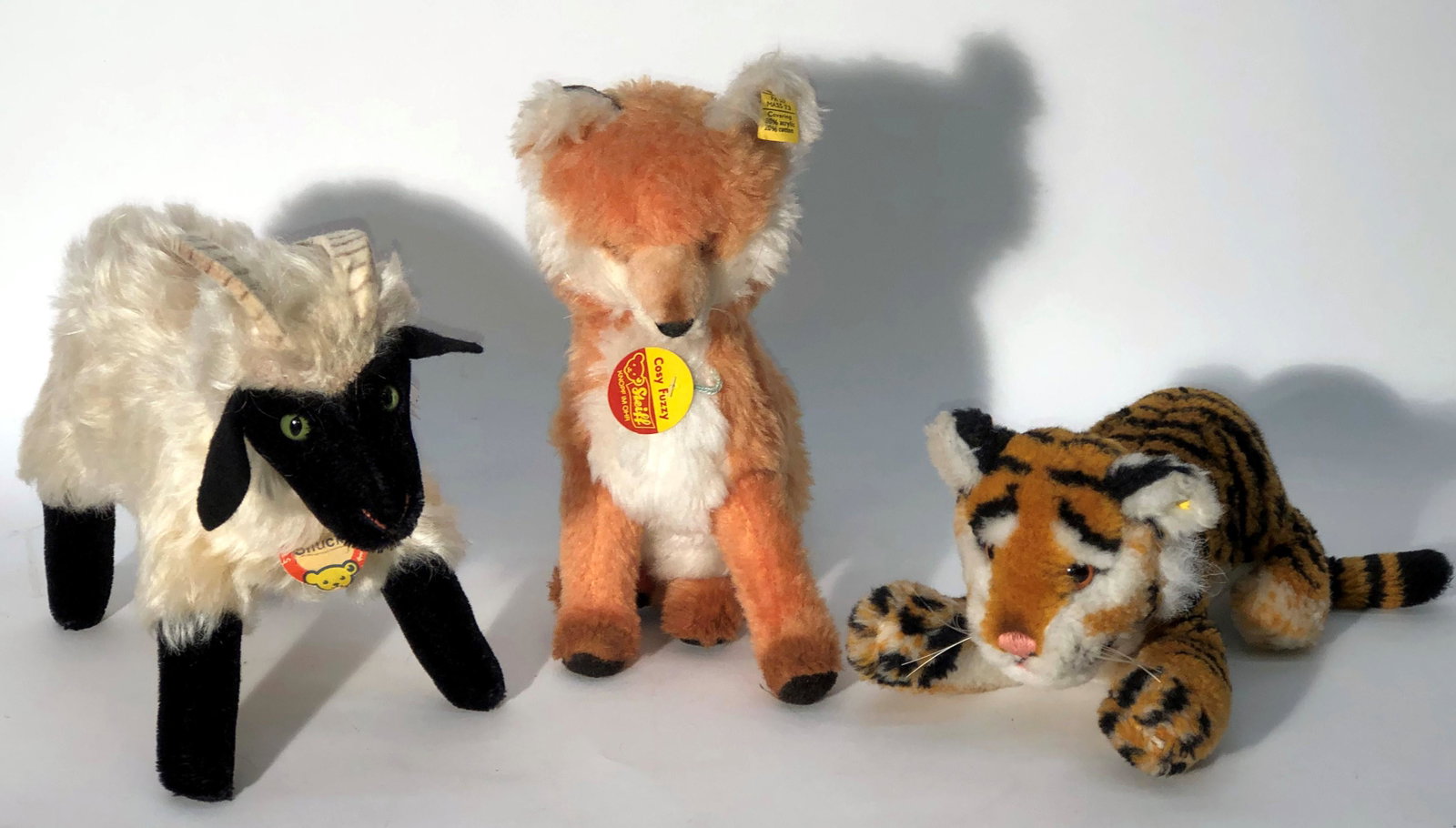 STEIFF ANIMALS (3): (1) Fox with ear button and tag; chest tag; (1) Tiger with ear button only; Mountain Goat with "Snucki"; chest tag only; H-4"-10"; normal wear; G-VG