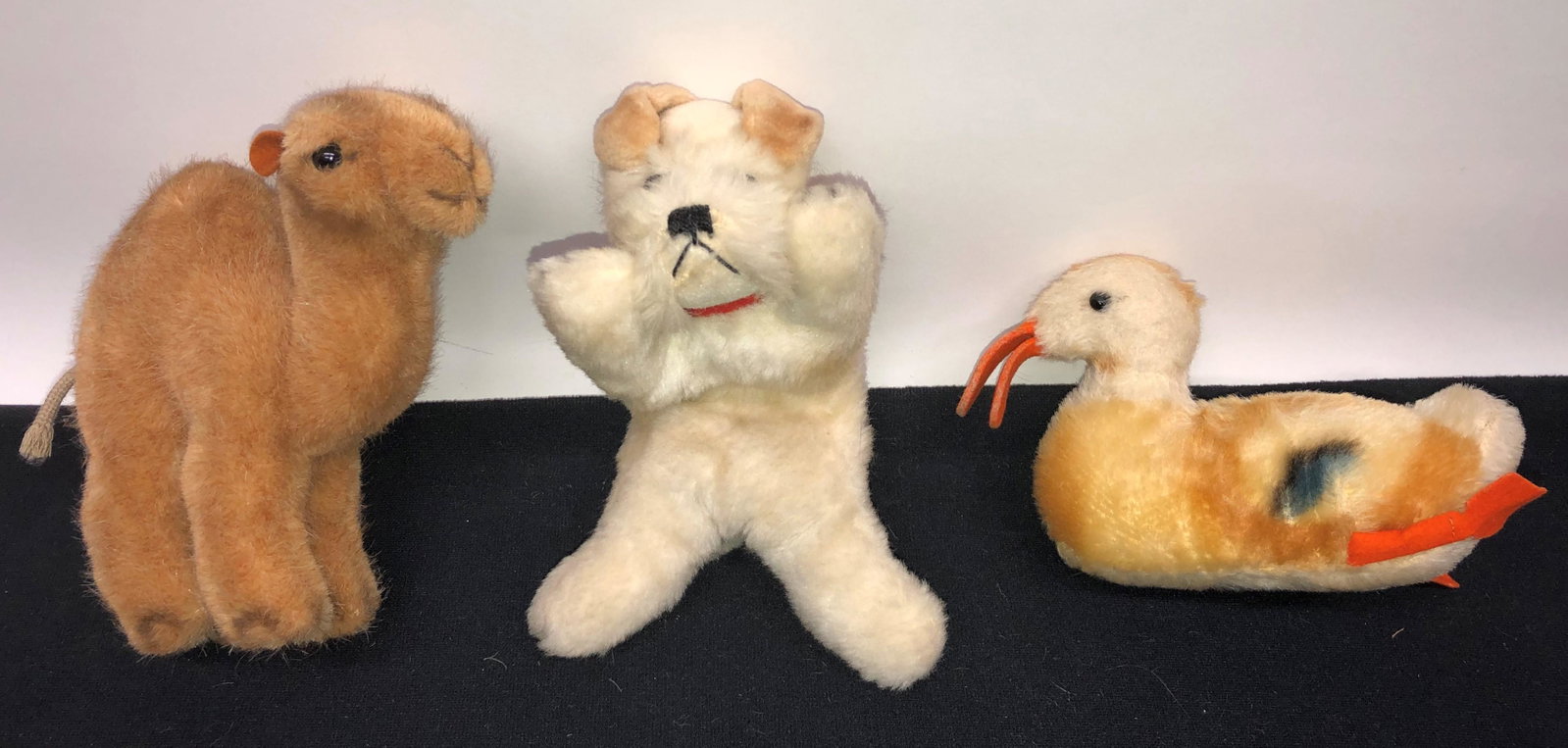 STEIFF ANIMALS (3): No ear buttons or tags; (1) camel; ear damage; (1) floppy dog; (1) duck; H-3"-6"; normal wear; G-VG