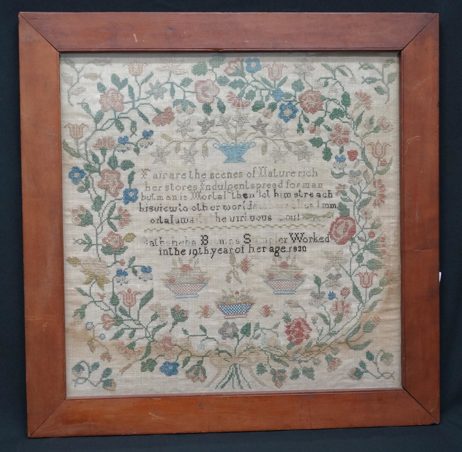 SAMPLER: Flowers, baskets, verse. 1830. Framed size 20x20. Faded letters. Some spotting. F-G