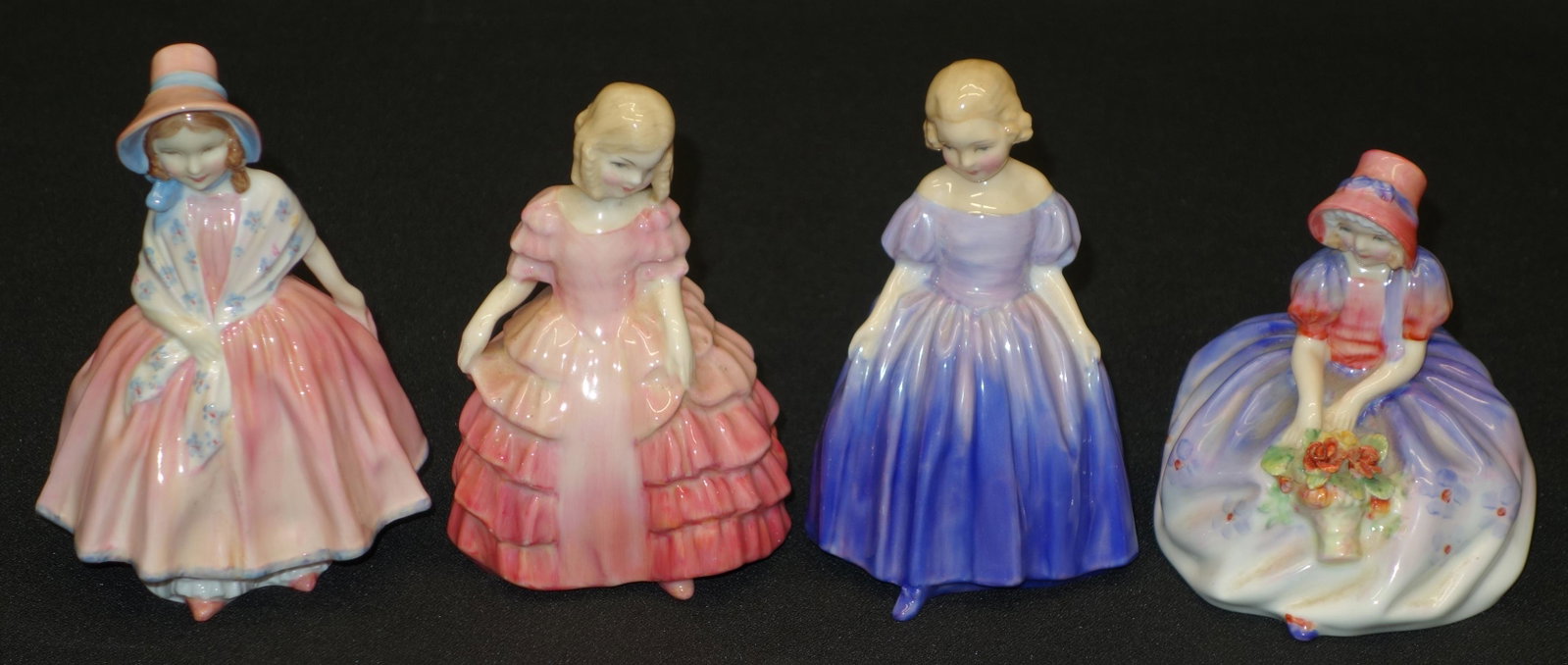 ROYAL DOULTON LADIES (4): Porcelain; "Monica"; "Marie"; "Rose"; "Lily"; "Lily" is severely cracked on bottom and has hairlines on backside; tallest- 5 1/2"; G-VG