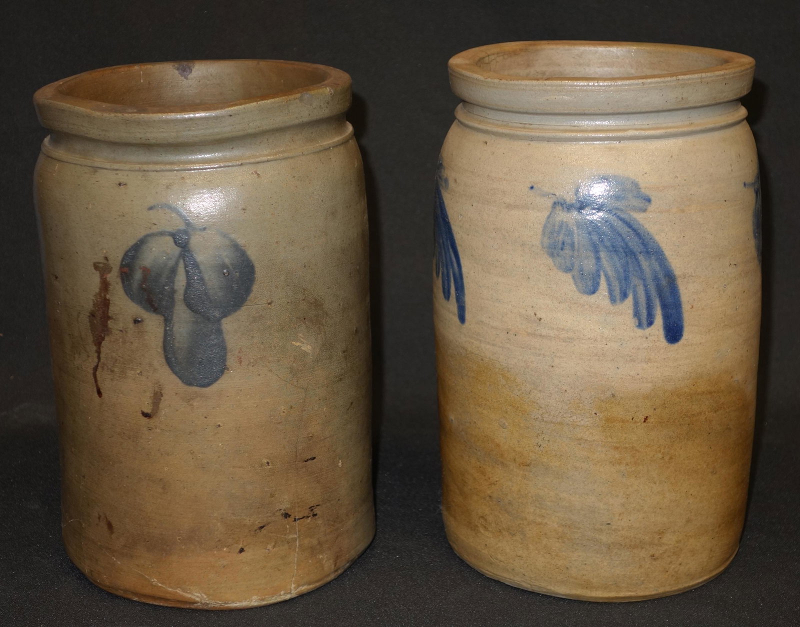 STONEWARE CROCKS- BLUE MOTIF (2): (1) has fine hairline spider on interior rim and 7" very fine hairline running from rim downward; (1) has (2) rim chips and spider hairlines up to 7" long coming from the bottom on one side; tallest- 
