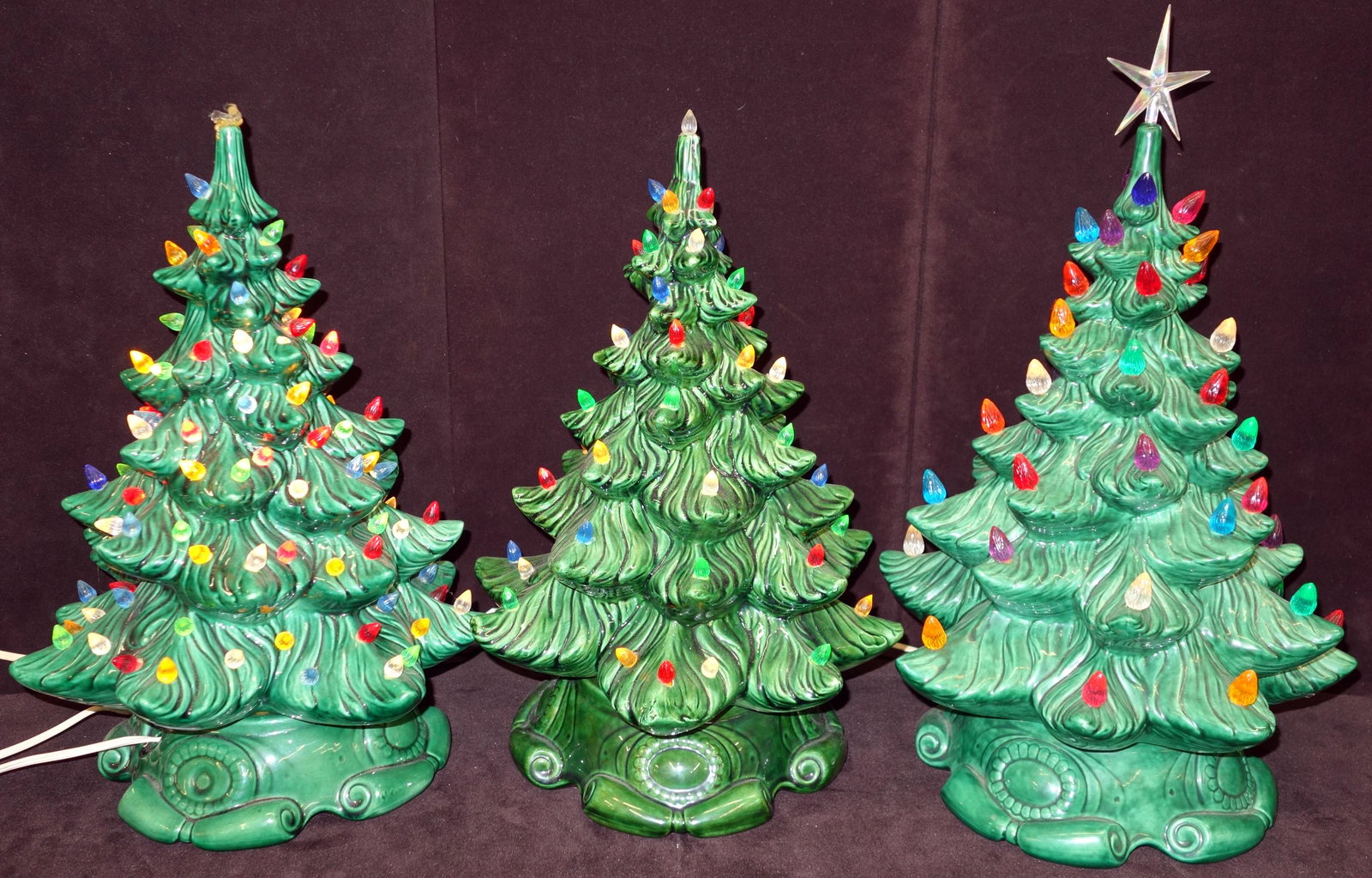 CERAMIC CHRISTMAS TREES (3): Plastic lights; electric; Christmas trees come in (2) pieces- base and top; (1) missing top ornament; (1) tree top chipped and missing top ornament; only found (1) missing light; tallest- 21"; G-VG