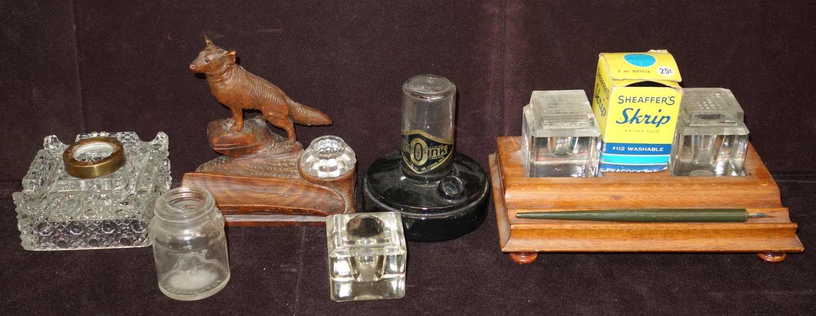 INKWELLS AND INK BOTTLES AND PEN: (1) carved wooden with glass; (1) wooden with (2) inkwells with caps; caps are chipped; (1) cut crystal with brass; cap lost; (1) ceramic and glass; (1) pen; W- 8"; F-G